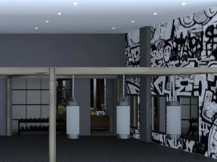 Interior of a modern gym or fitness center with punching bags, wall graffiti, and fitness equipment.