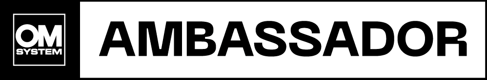 OM SYSTEM ambassador logo with black text on white background.