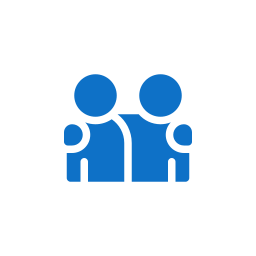 Icon of two blue people sitting at a desk with laptops, representing collaboration or teamwork