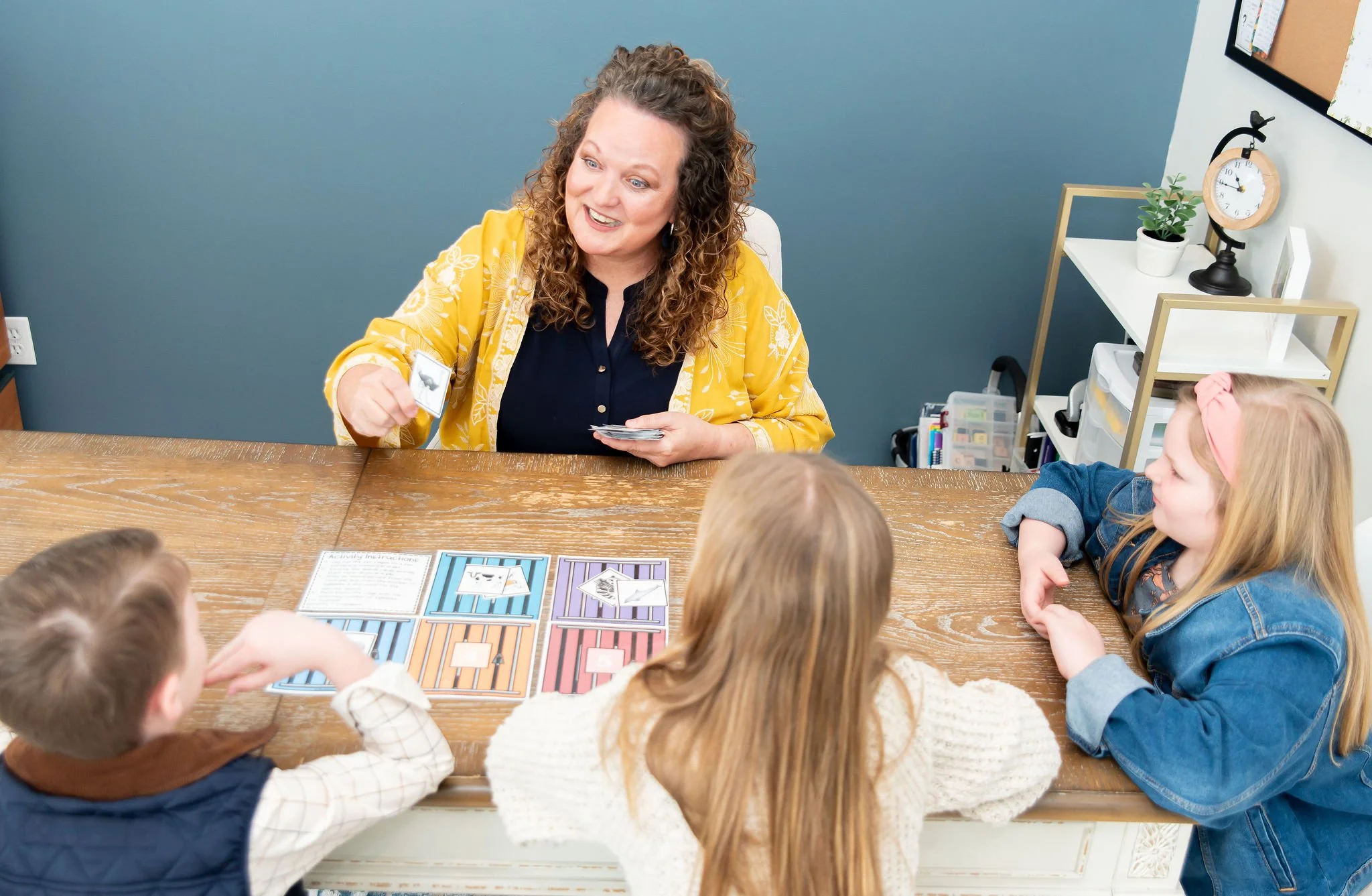 Female tutor playing a syllable learning game with two elementary ages students at The Firm Foundation Learning Center