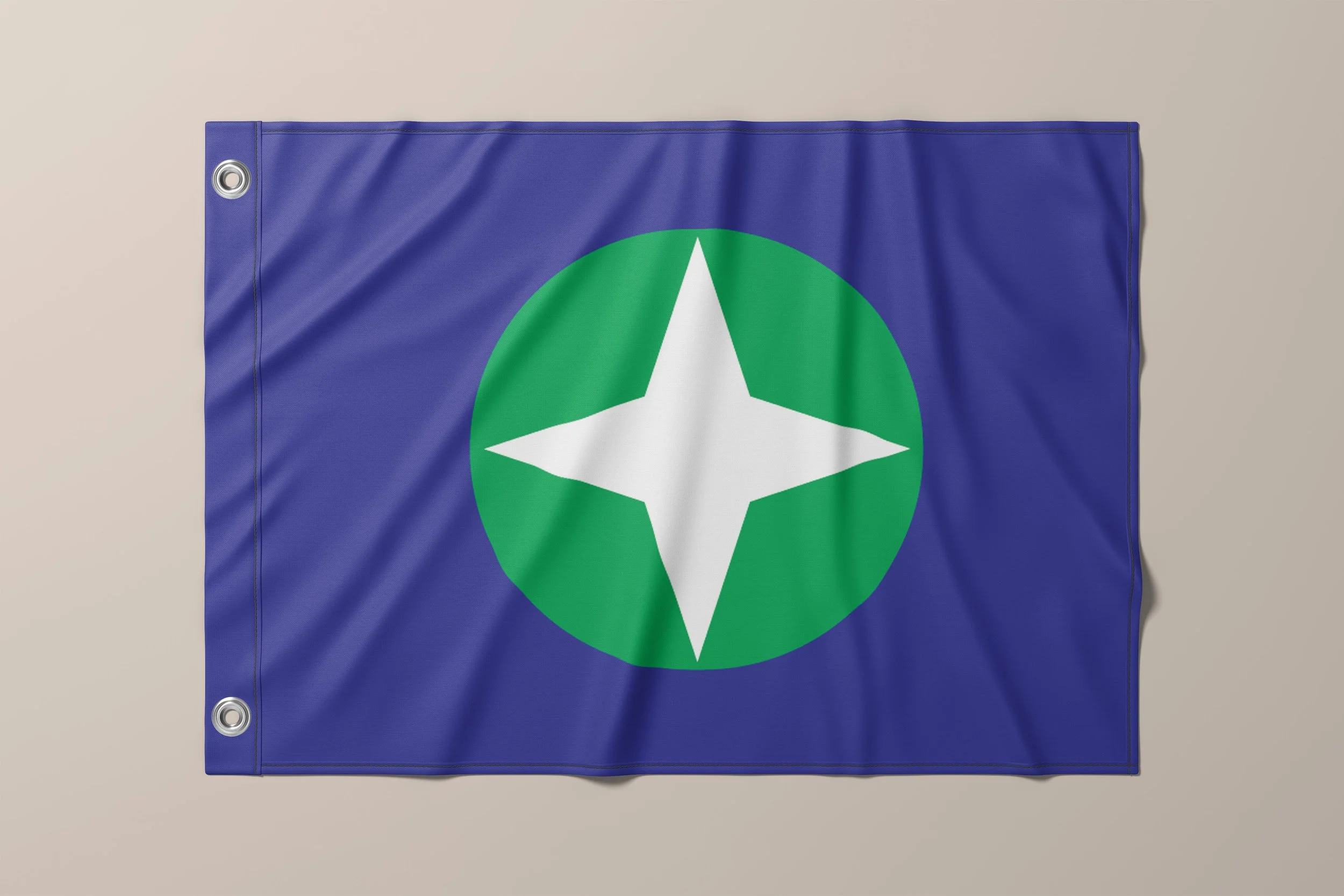 The flag design features blue, green, and the four pointed star arranged purposely. The center design is both the land surrounded by the blue lakes and a compass as a tribute to all of the sailors who brave the waters.