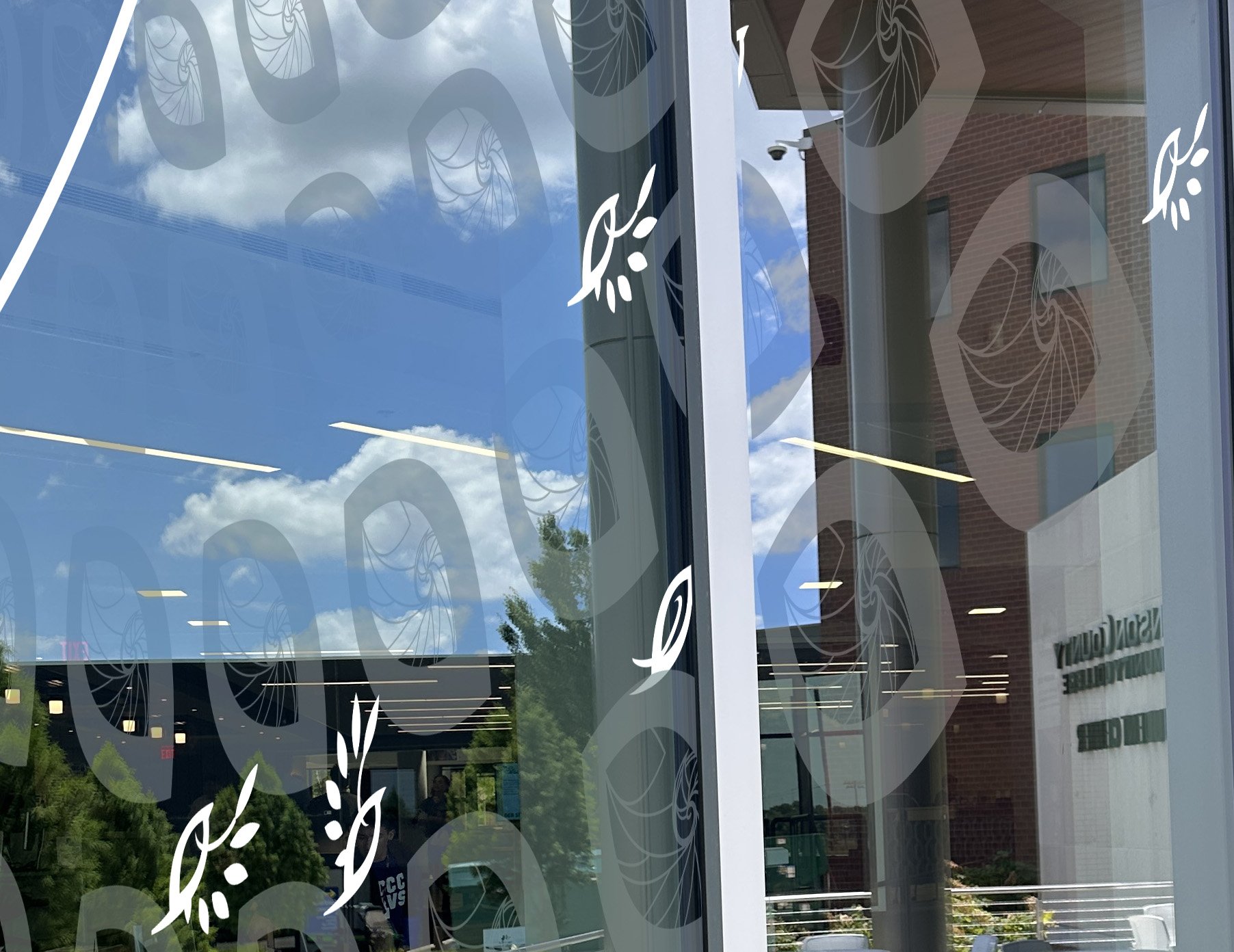 A close up of the details in the white and etched glass vinyl on the North side of the Student Center.