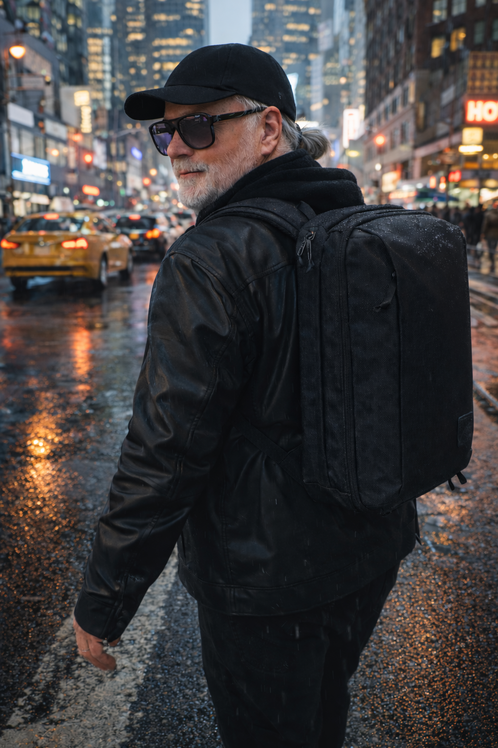 RC wearing a backpack walking through the city after a rainfall at night.