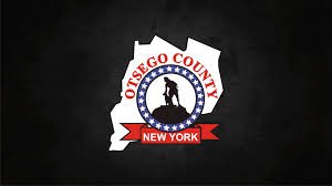JUNK REMOVAL IN OTSAGO County, New York emblem with a silhouette of a person on a horse in the center, surrounded by a circular border with the text 'OTISAGO COUNTY,' and a red banner with 'NEW YORK' at the bottom.
