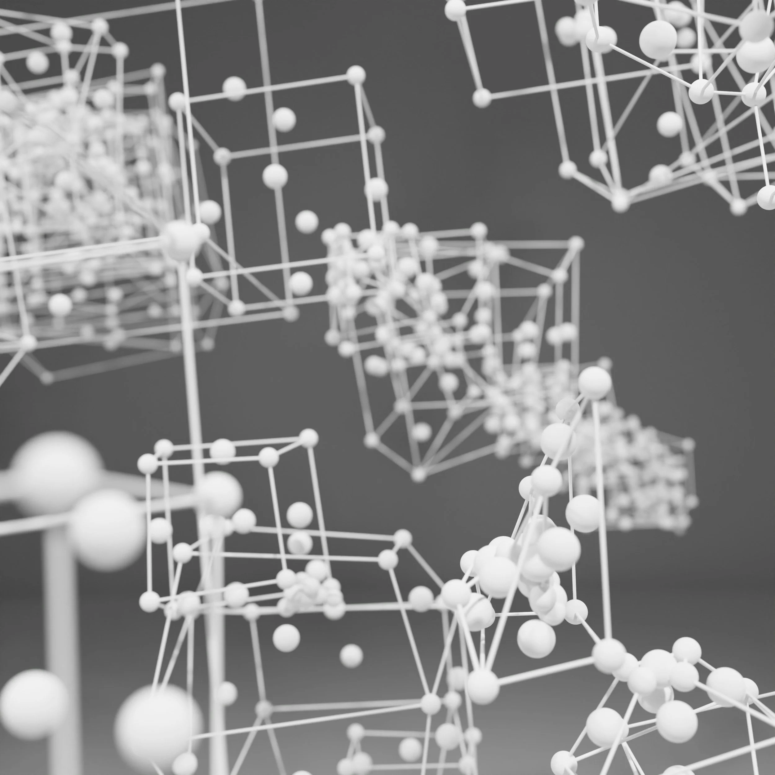 A close-up of an abstract, geometric sculpture made of white interconnected rods and spherical nodes.