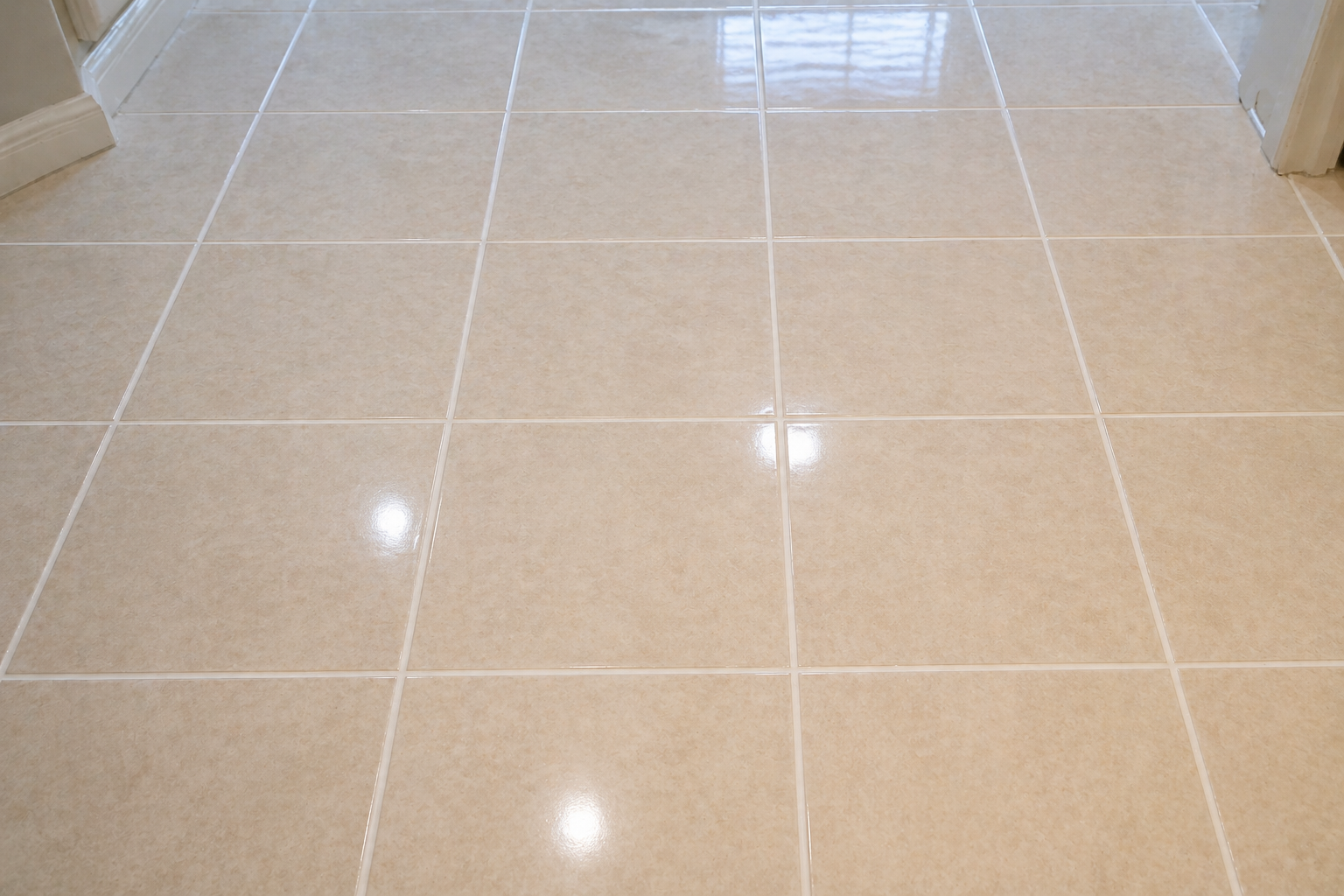 Cream-colored tiled floor with grout lines, reflecting light.