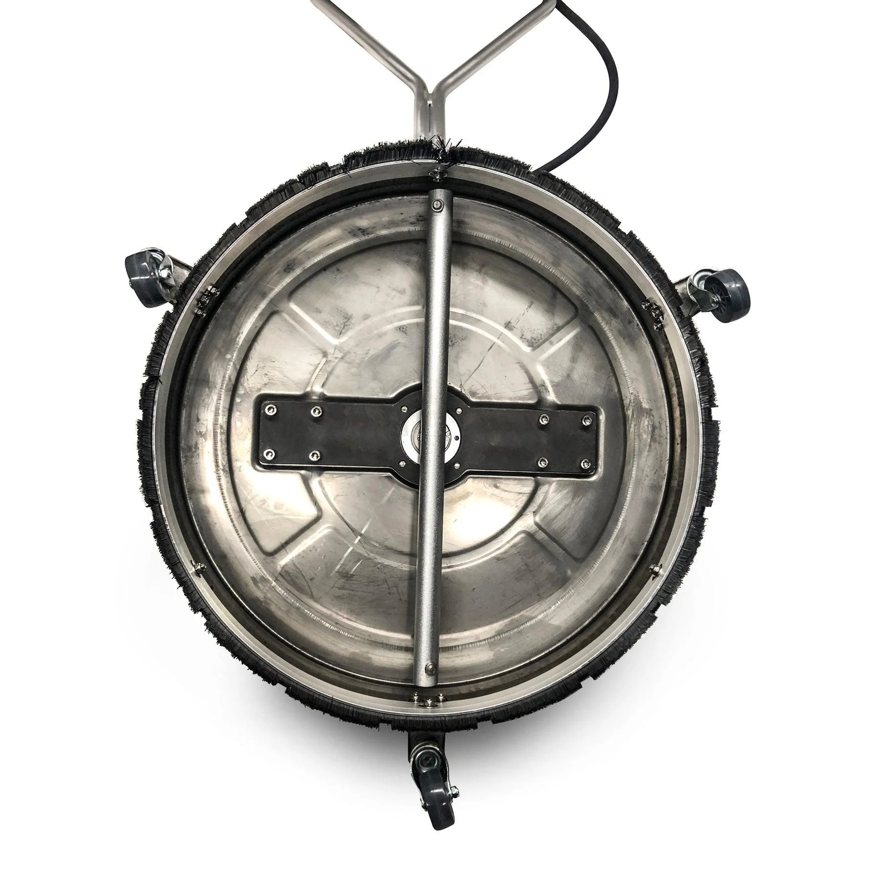 The image shows the bottom part of a circular floor cleaning machine with a black cleaning brush around the edge and a metal handle extending upward. There are wheels on the sides and a cord attached to the handle.