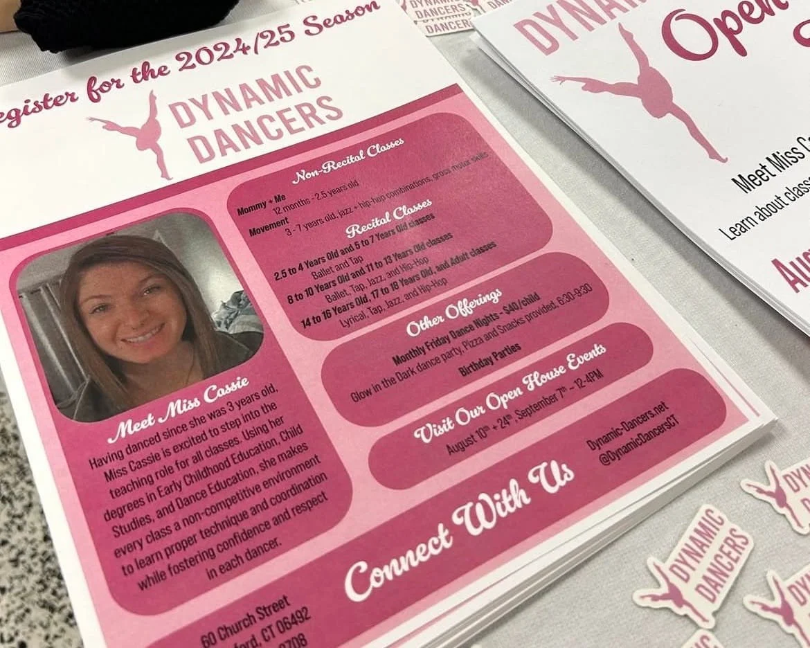 A flyer designed by Chelsea is laid out on a table with branded stickers. 