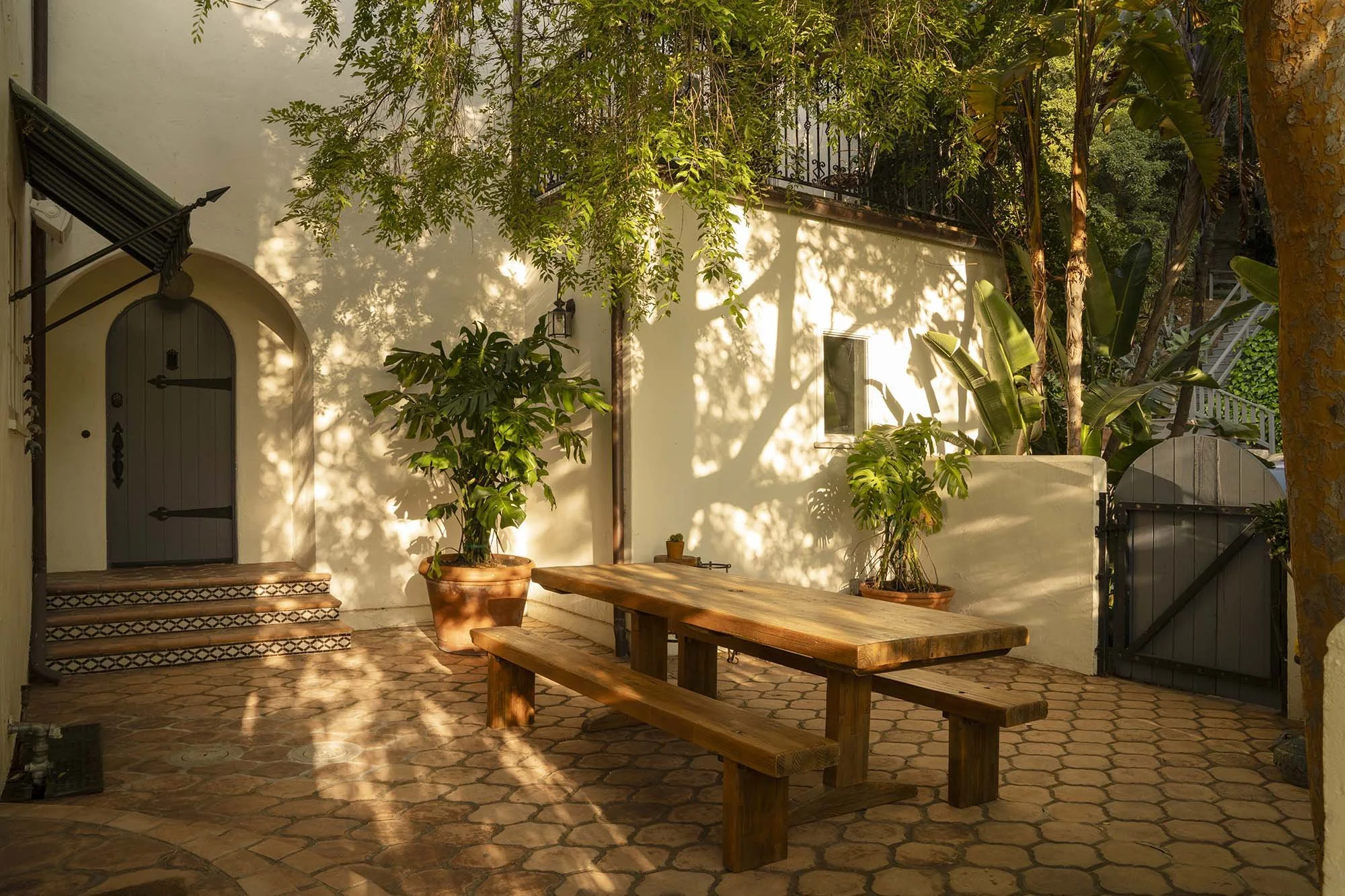 PL6014-034-courtyard-picnic-table-benches-dappled-light.jpg