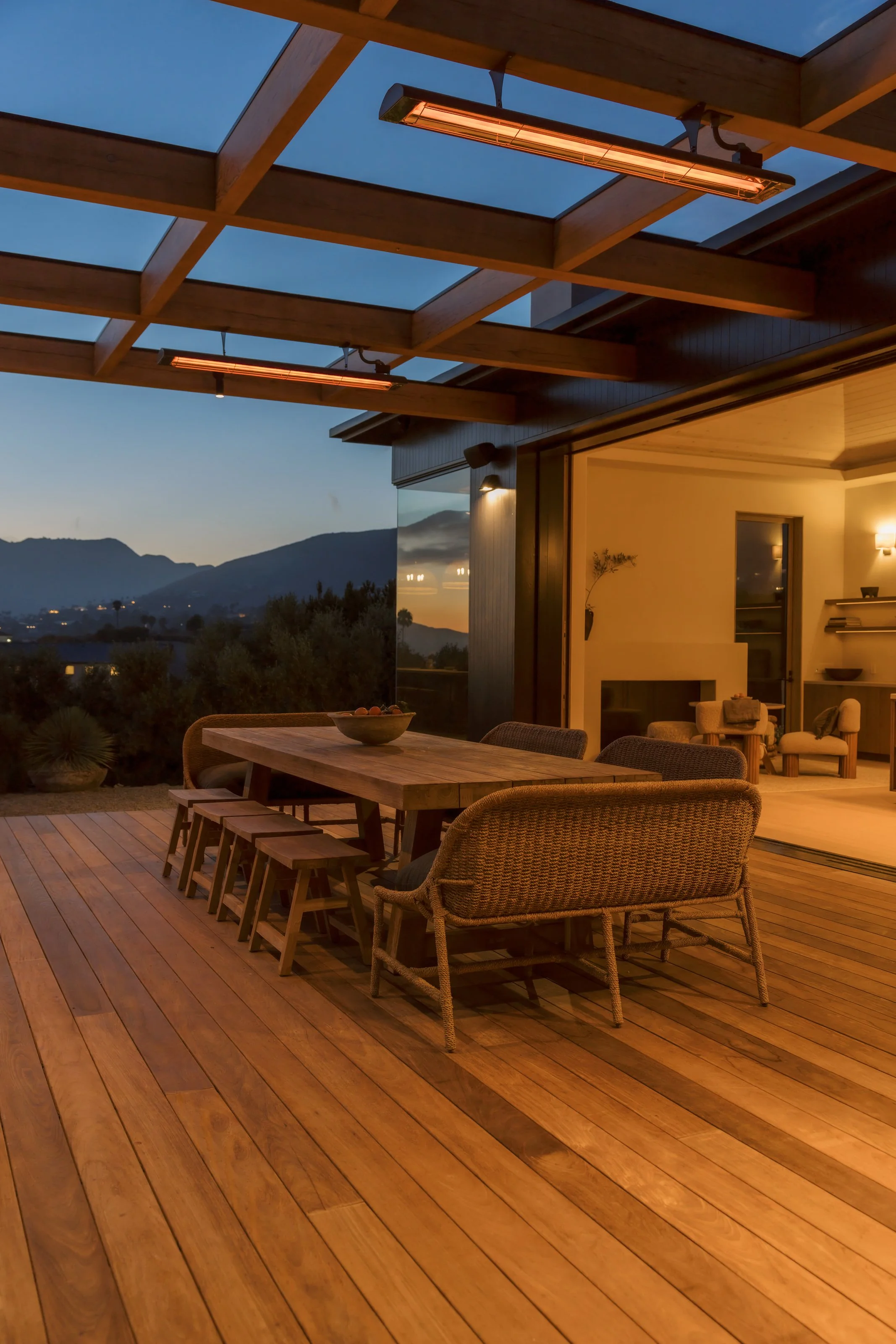 Covered dining terrace and hills at dusk