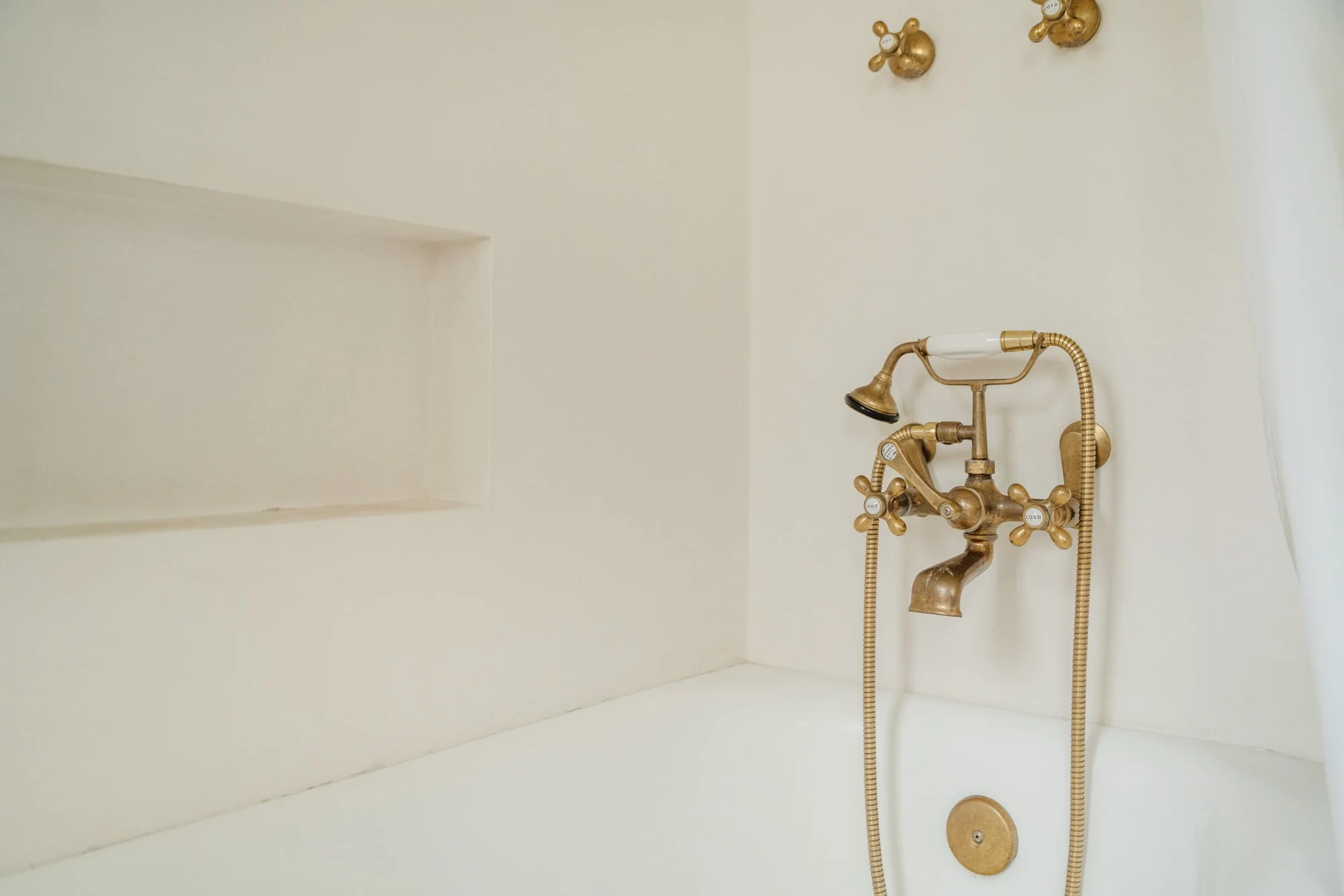 Bathroom — bathtub and brass fixture detail