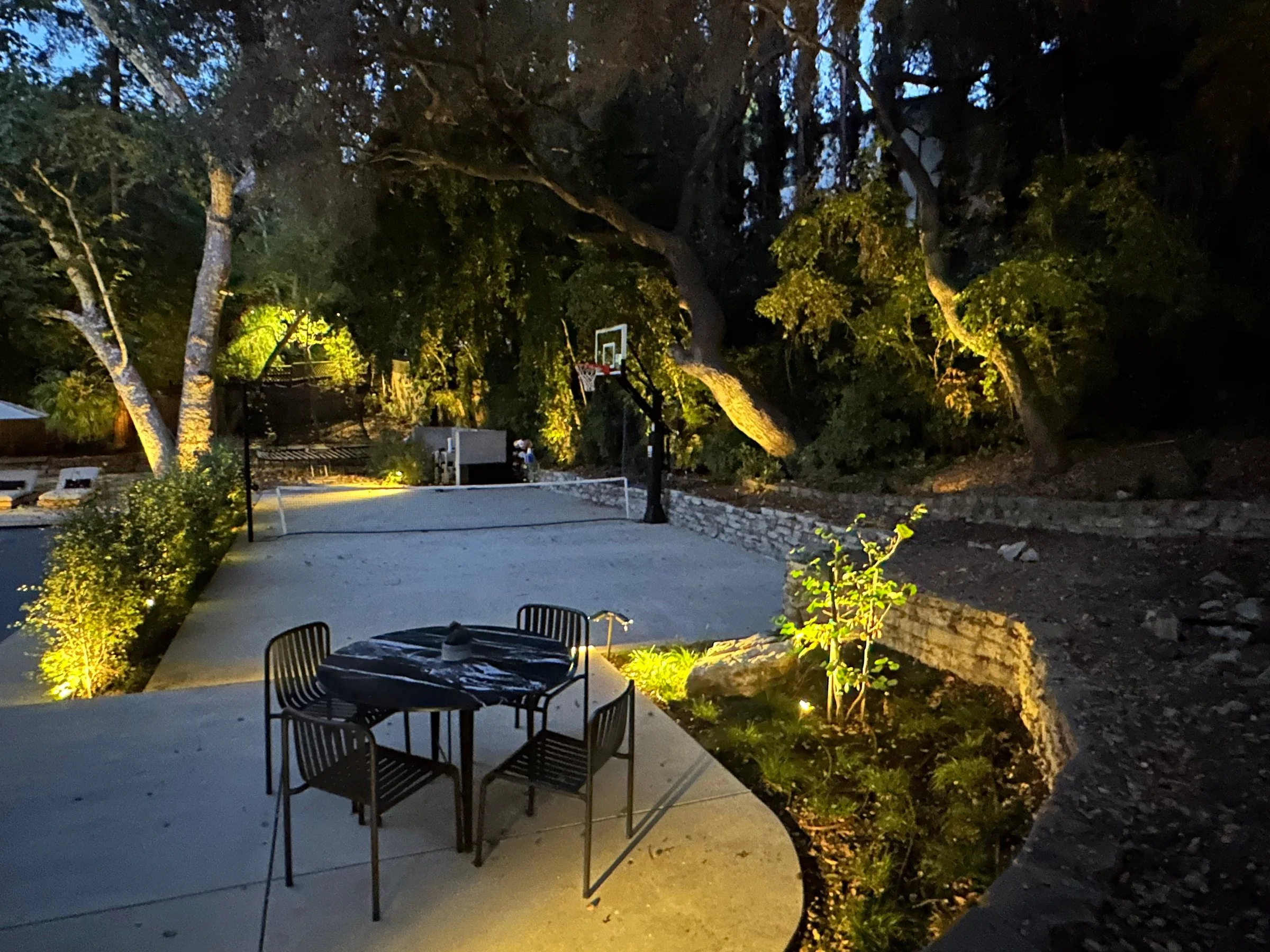 Sport court and dining patio at night. | PL-3803