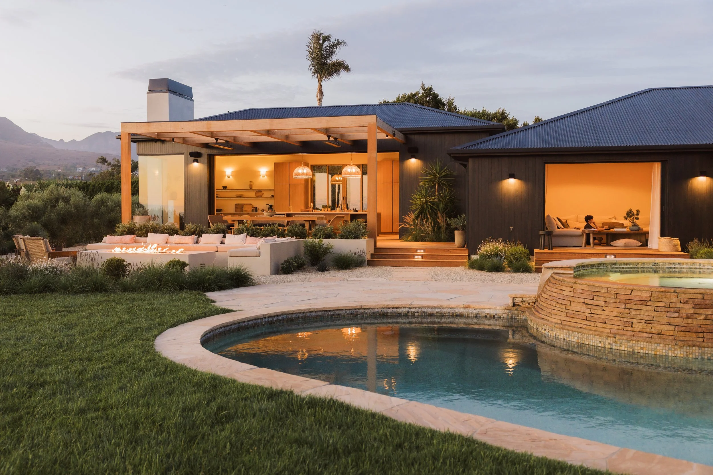 Wide pool and rear garden at dusk