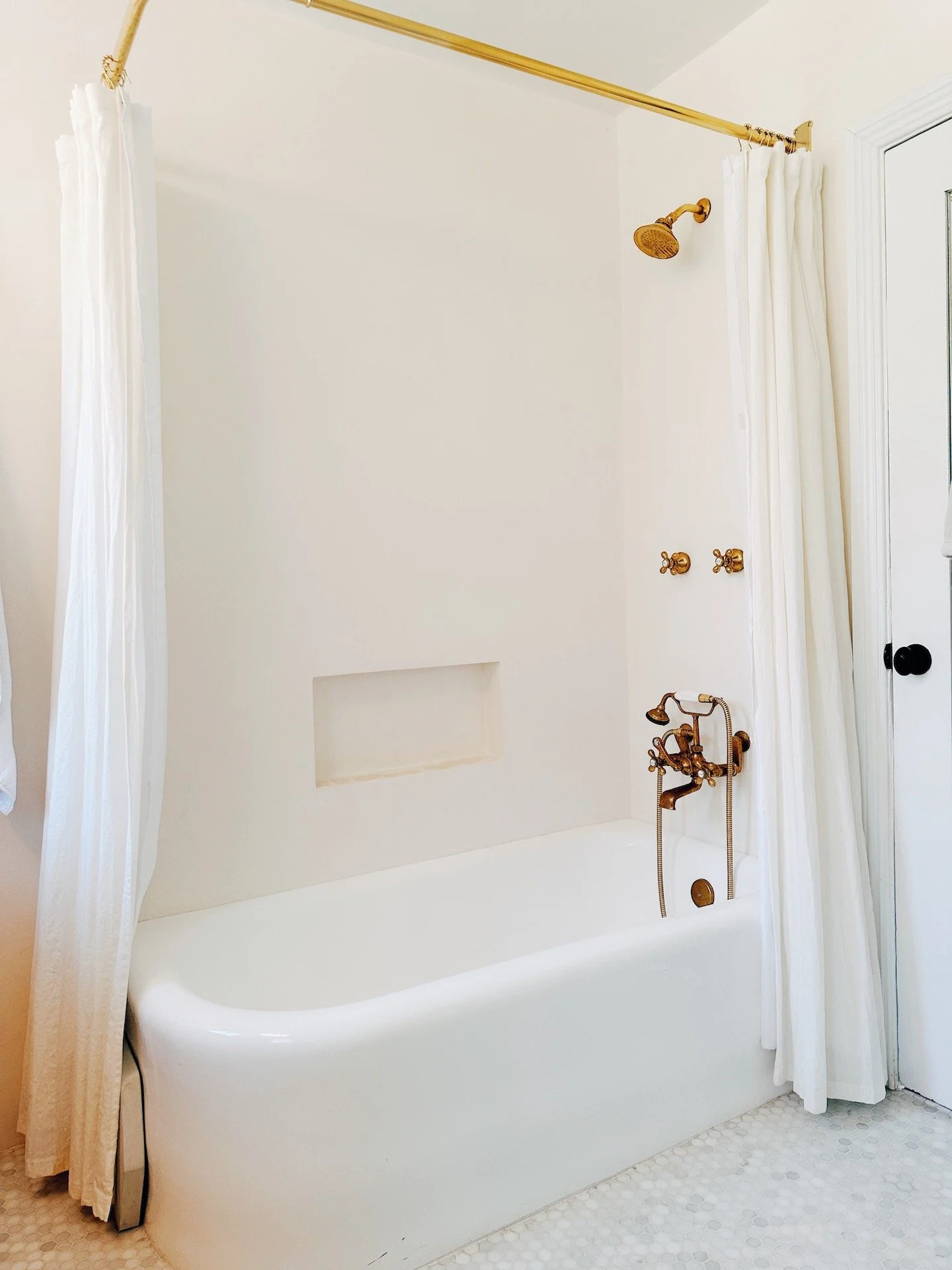 Bathroom — bathtub and brass fixtures