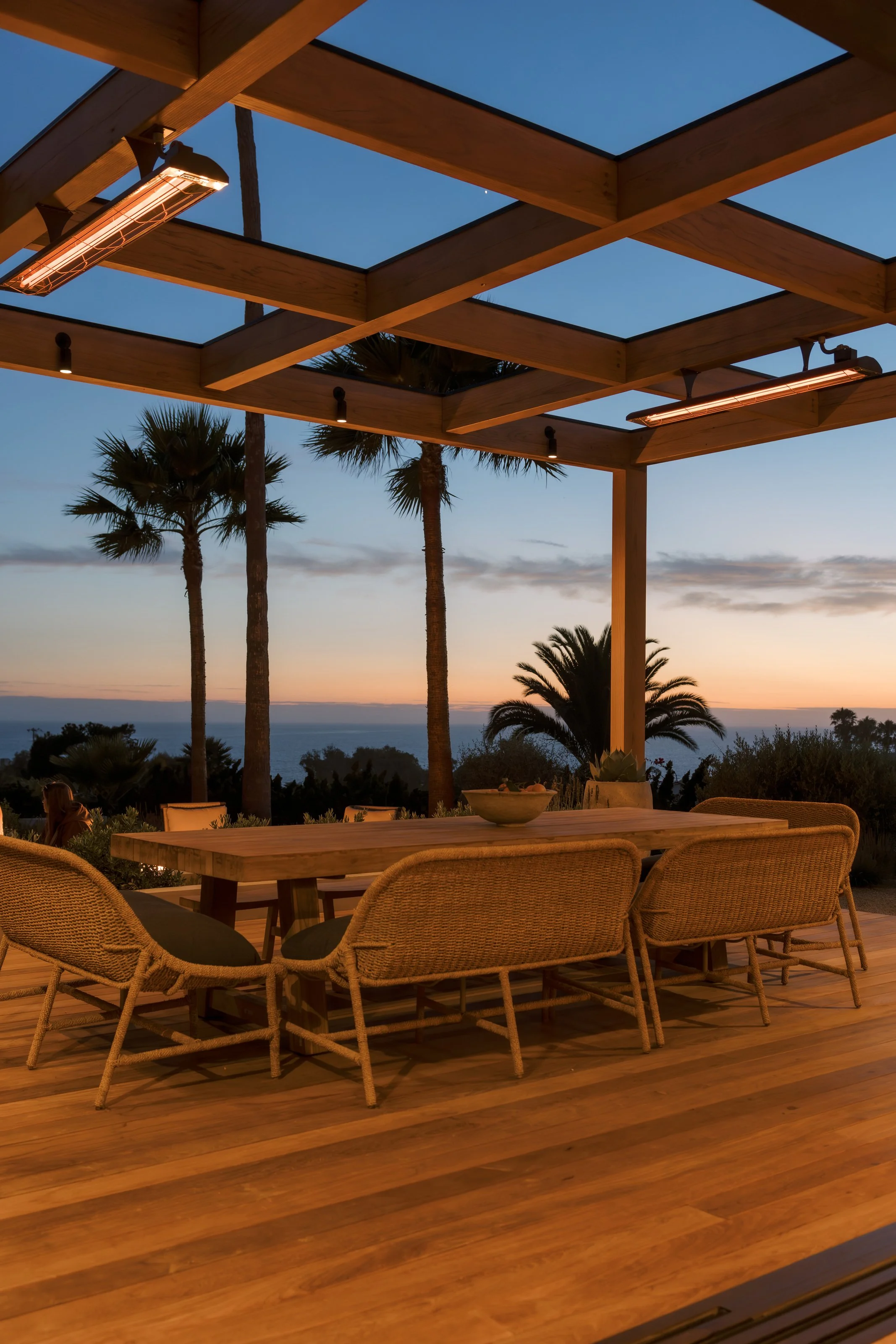 Dining terrace facing the sunset and palm trees