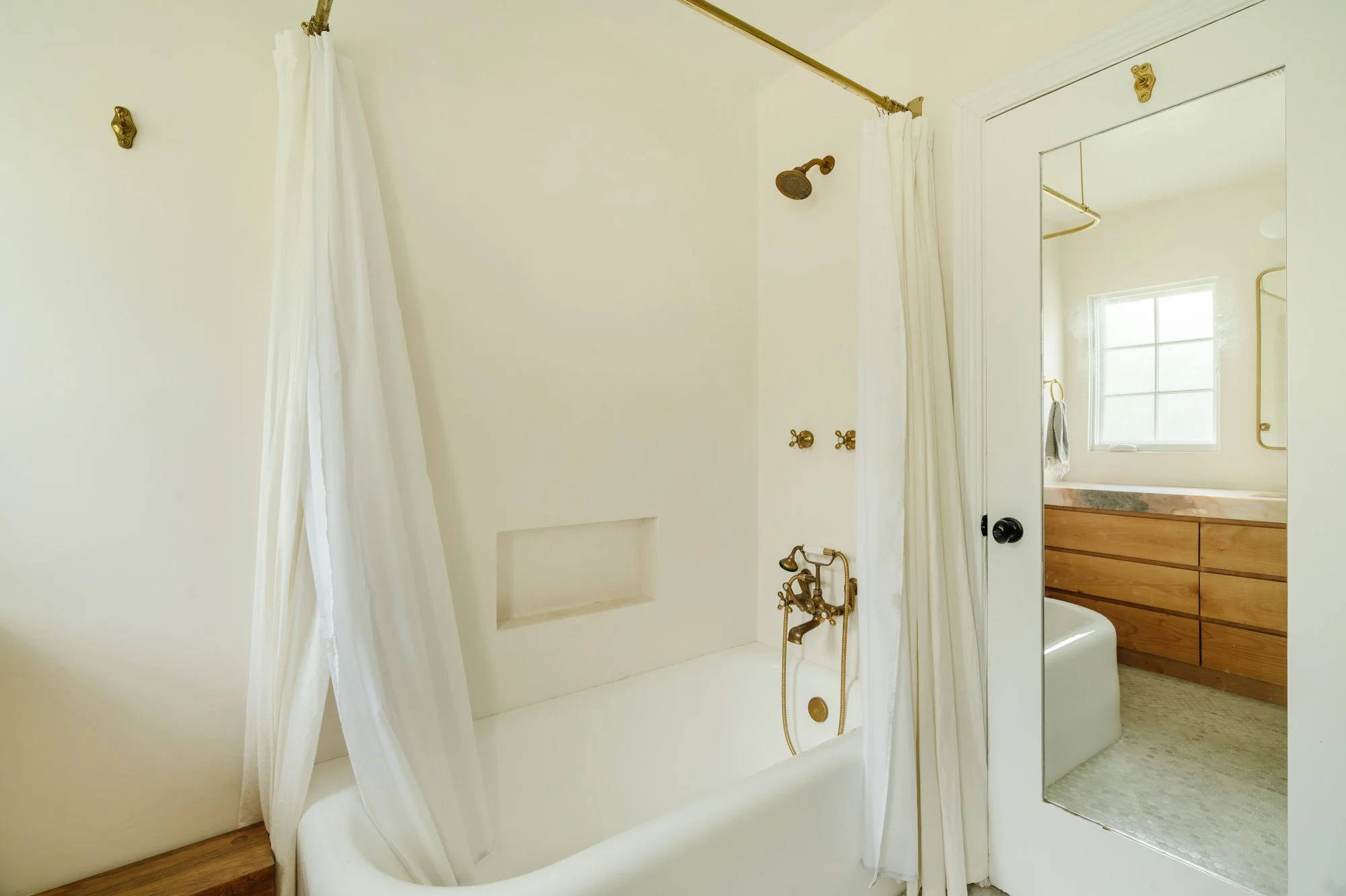 Bathroom — bathtub, brass fixtures and vanity