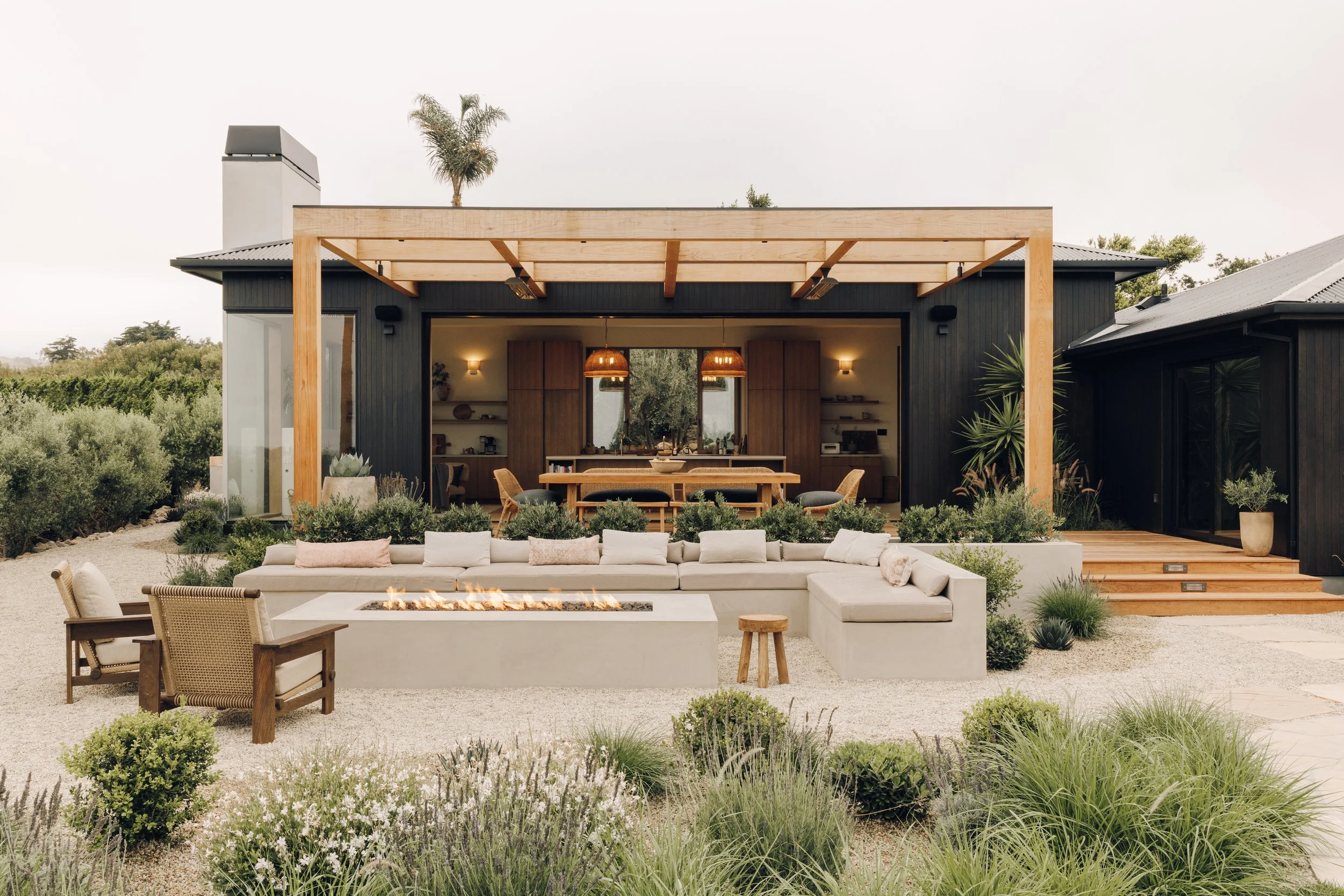 Rear exterior and sunken outdoor lounge in daylight