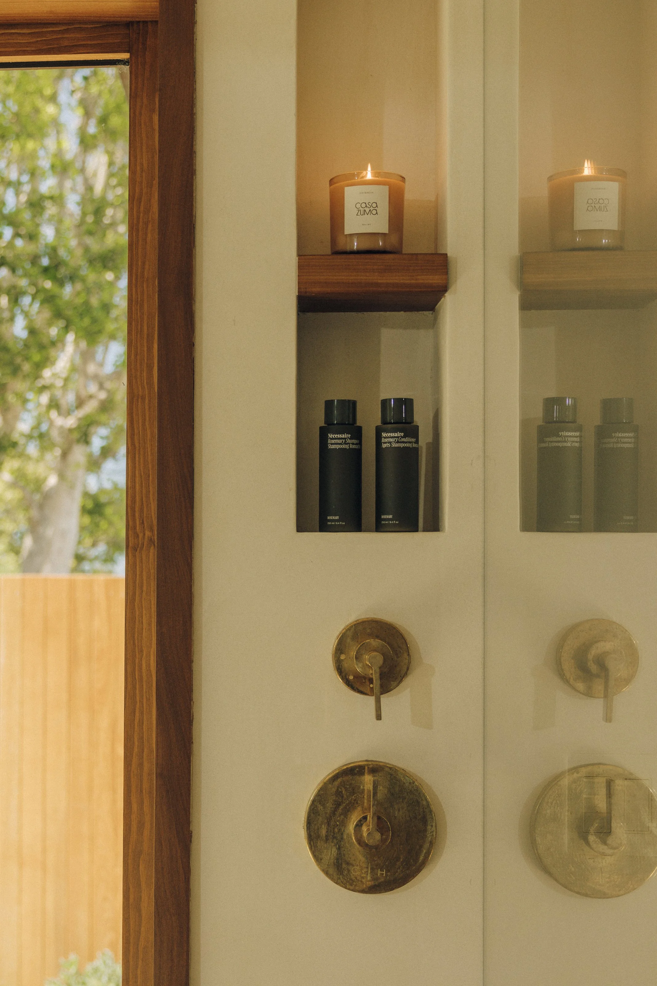 Shower with brass fixtures and garden window