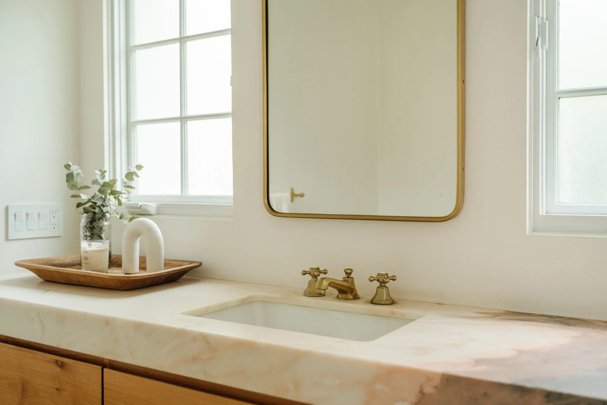 Bathroom — stone vanity and brass fixtures
