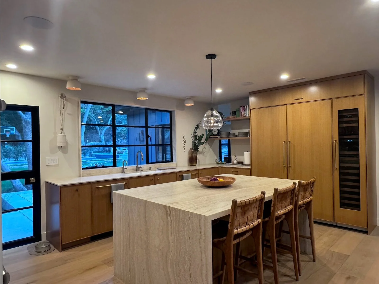 Kitchen with a large island, wood cabinetry and garden views. | PL-3803