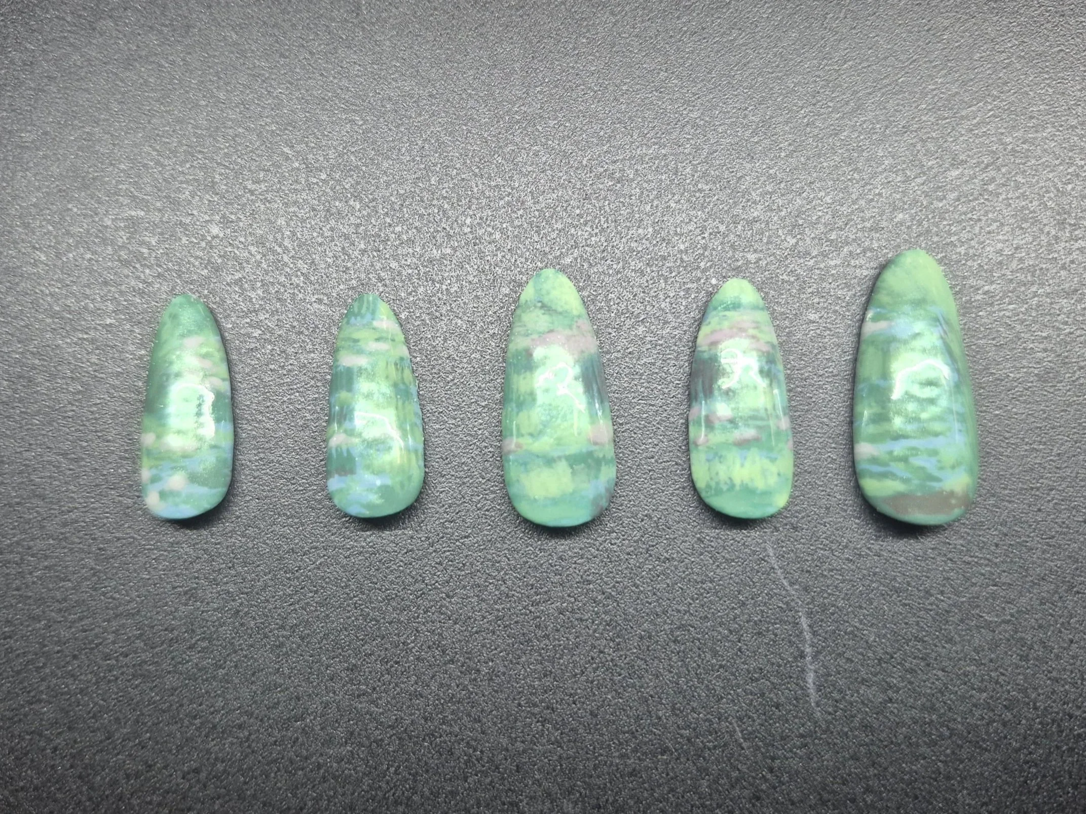Inspired by Monet's Water Lilies, this is a custom array of impressionism nails made with gel polish and buffed with green chrome.