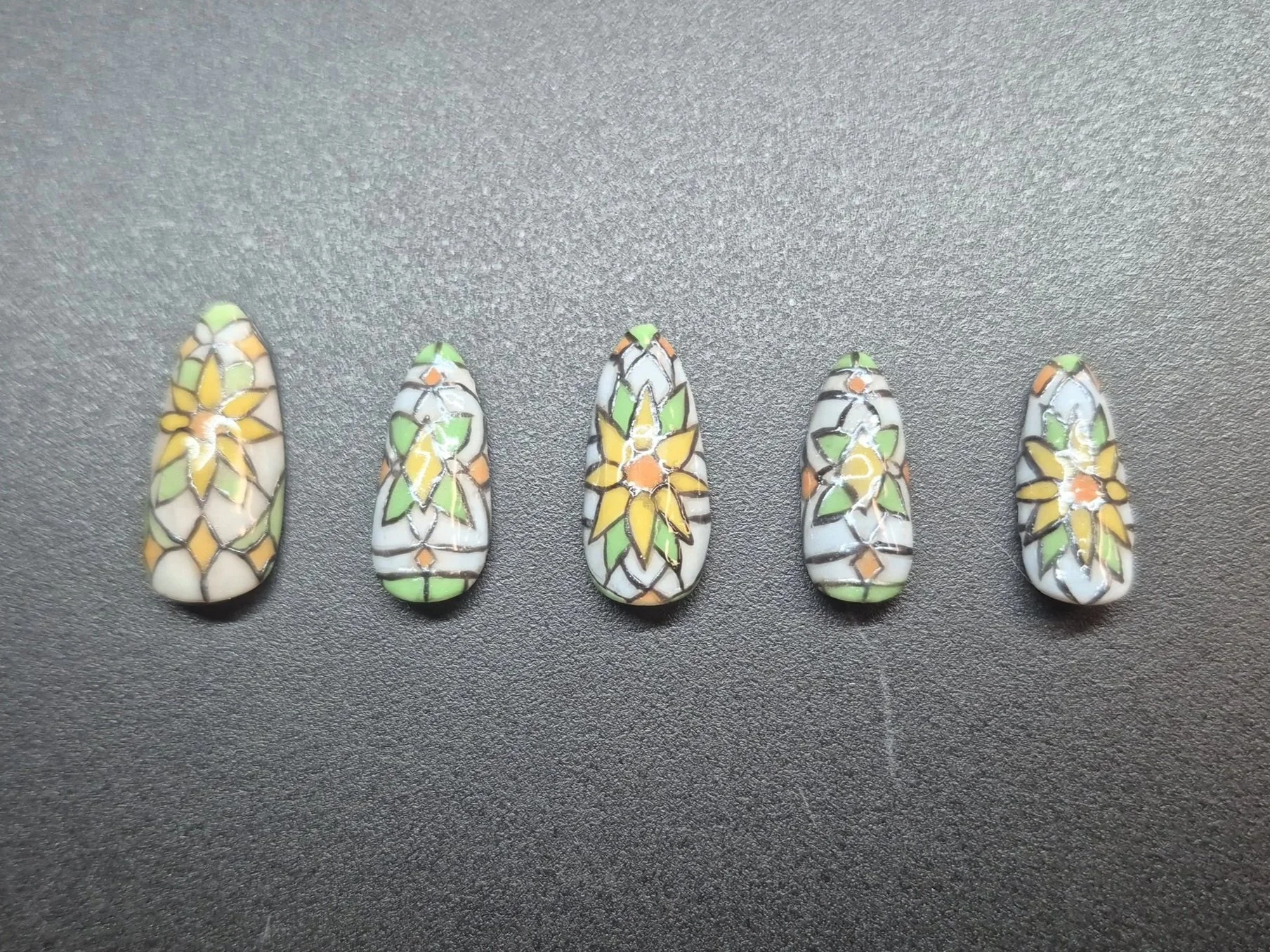 Inspired by a selection of beautiful stained glass window hangings I found on Etsy, these nails were made with gel polish and have black chrome buffed into the iron detailing.