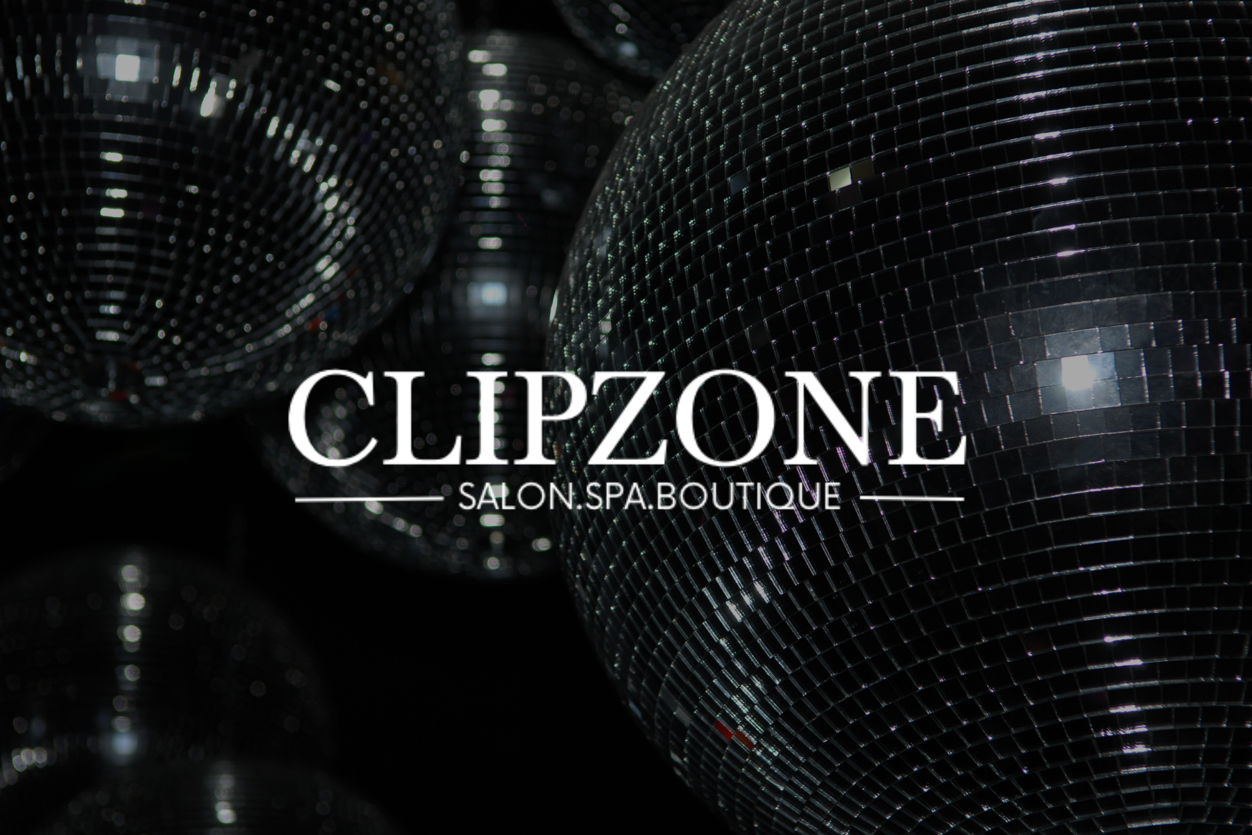 Close-up of mirror ball surfaces with the text 'CLIPZONE SALON SPA BOUTIQUE' overlayed.
