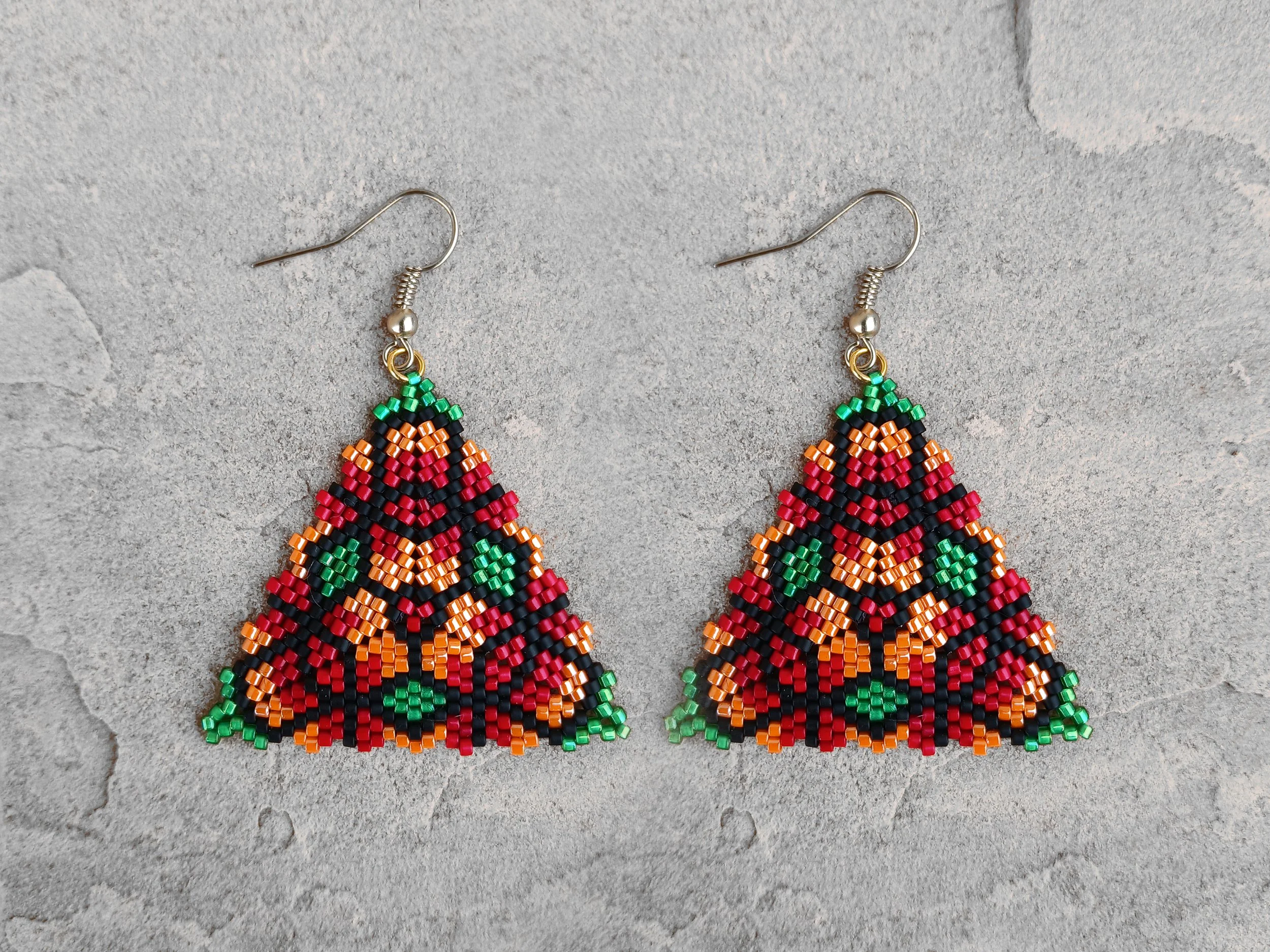 Handmade triangle peyote earrings with geometric floral pattern in red, green, orange, and black Miyuki Delica glass beads