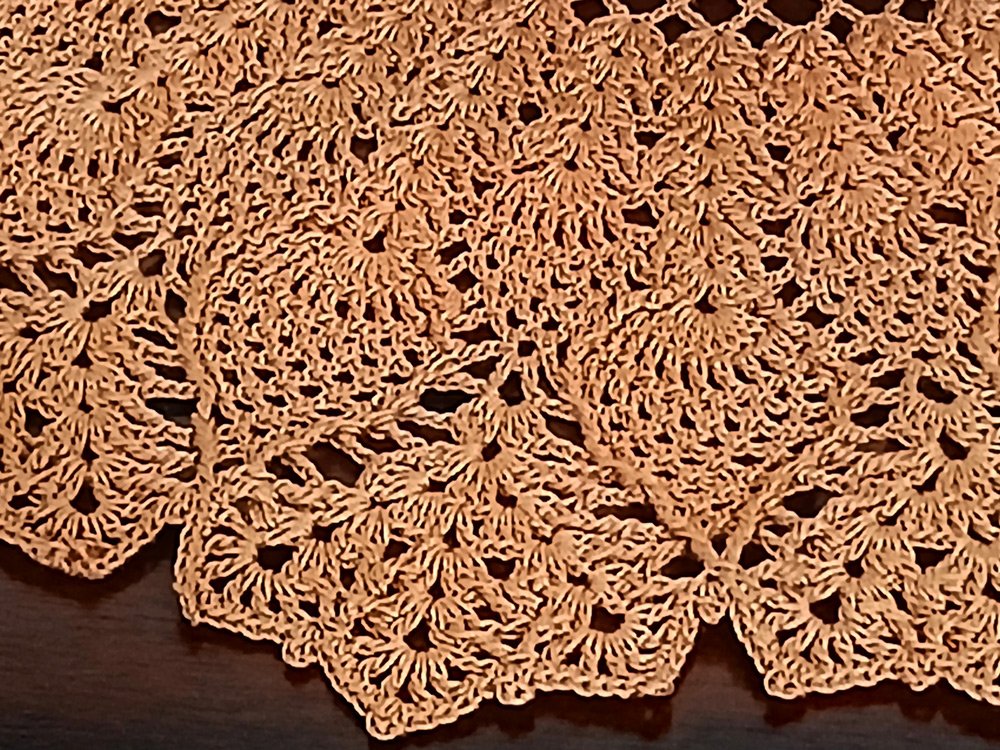 Exquisite and highly detailed 17-inch round crochet lace doily handwoven in a warm topaz color with a dimensional pineapple pattern
