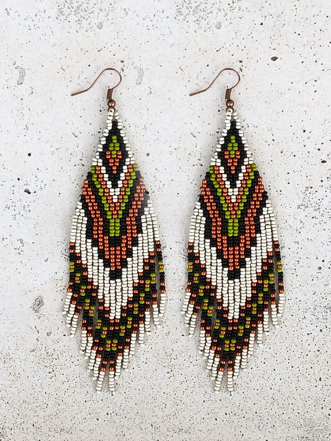 Handmade 5” beaded fringe earrings handwoven in chevron brick stitch with earthy green, matte silver, black, and copper.