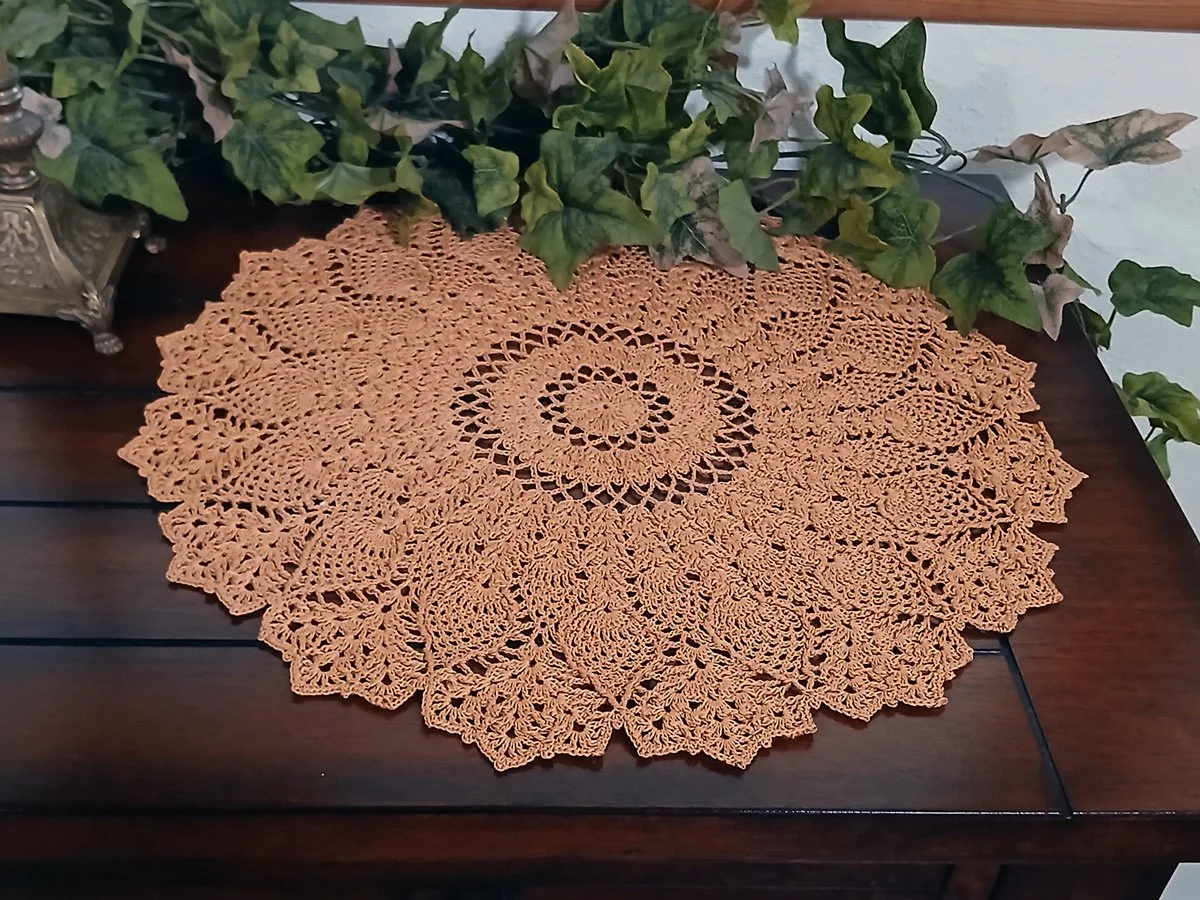 Exquisite and highly detailed 17-inch round crochet lace doily handwoven in a warm topaz color with a dimensional pineapple pattern