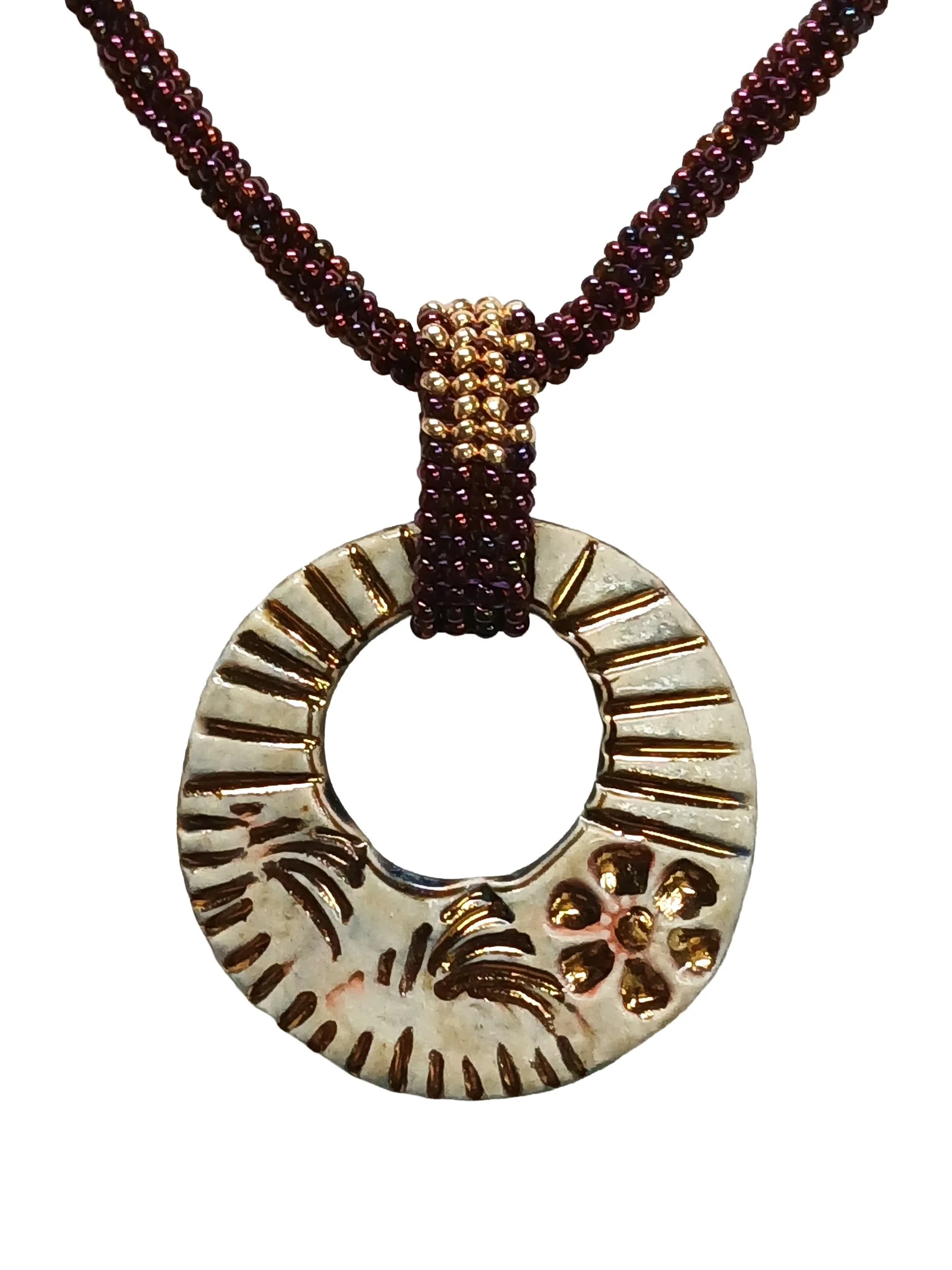 Handmade non-metal beaded herringbone chain necklace with open round ceramic pendant, handwoven in metallic iris rose and gold accents with a beaded toggle clasp.