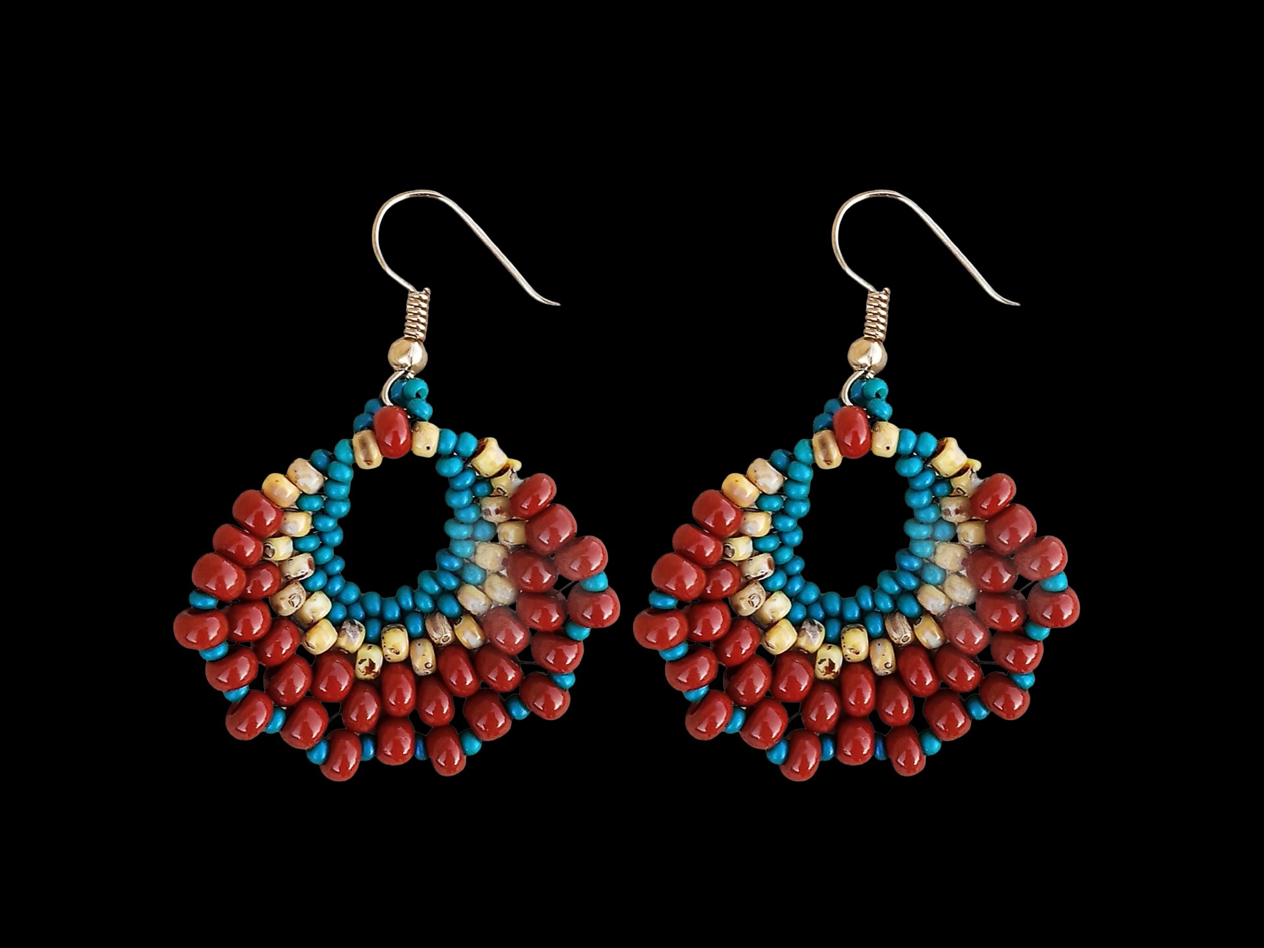 Bohemian brick-stitch beaded crescent fan earrings in rust red-brown, Picasso tan, and teal blue seed beads on a white background.