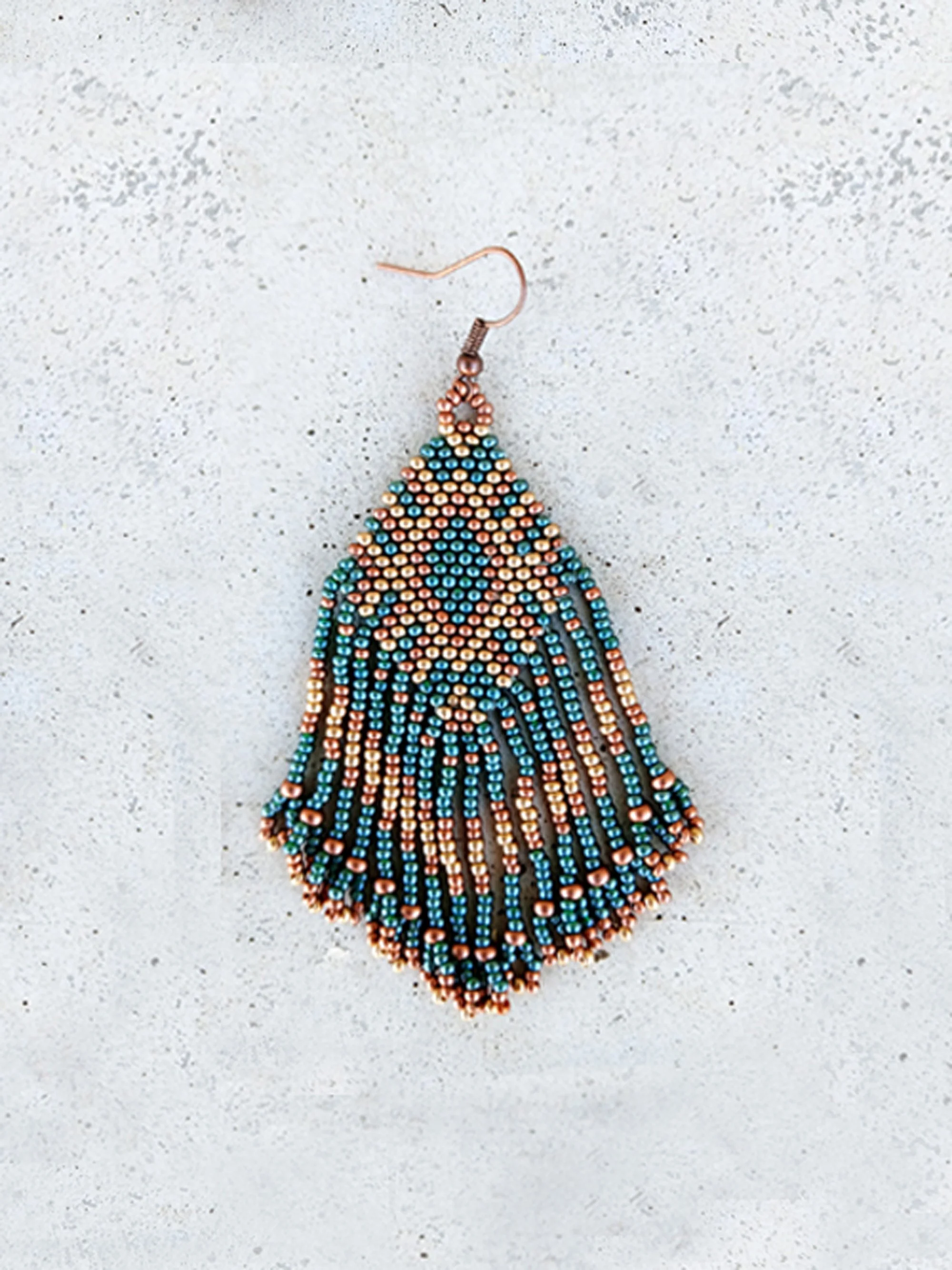 Medium-length beaded fringe earrings with metallic bronze, gold, and green seed beads in a tribal geometric pattern