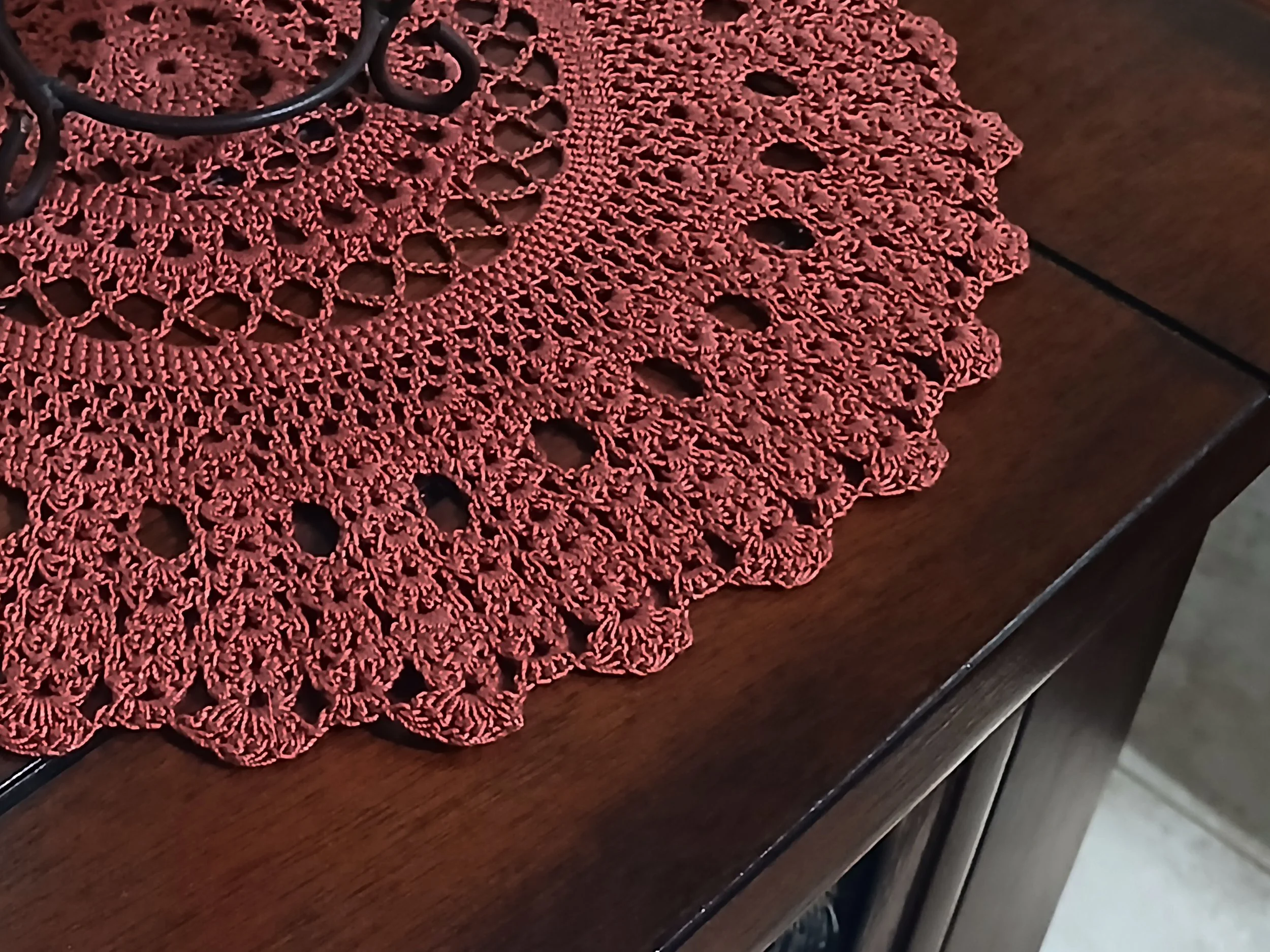 Handmade 12 inch crochet round lace doily in deep rust color, featuring intricate traditional pattern 100% mercerized cotton