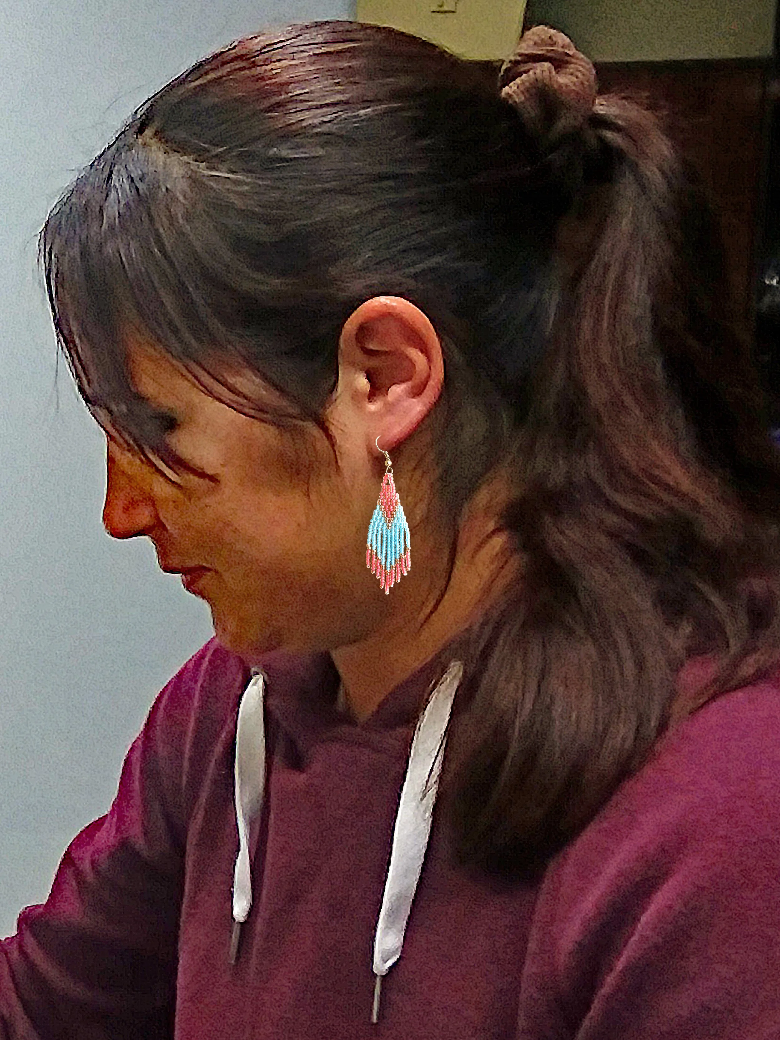 model wearing turquoise coral gold short fringe beaded earrings