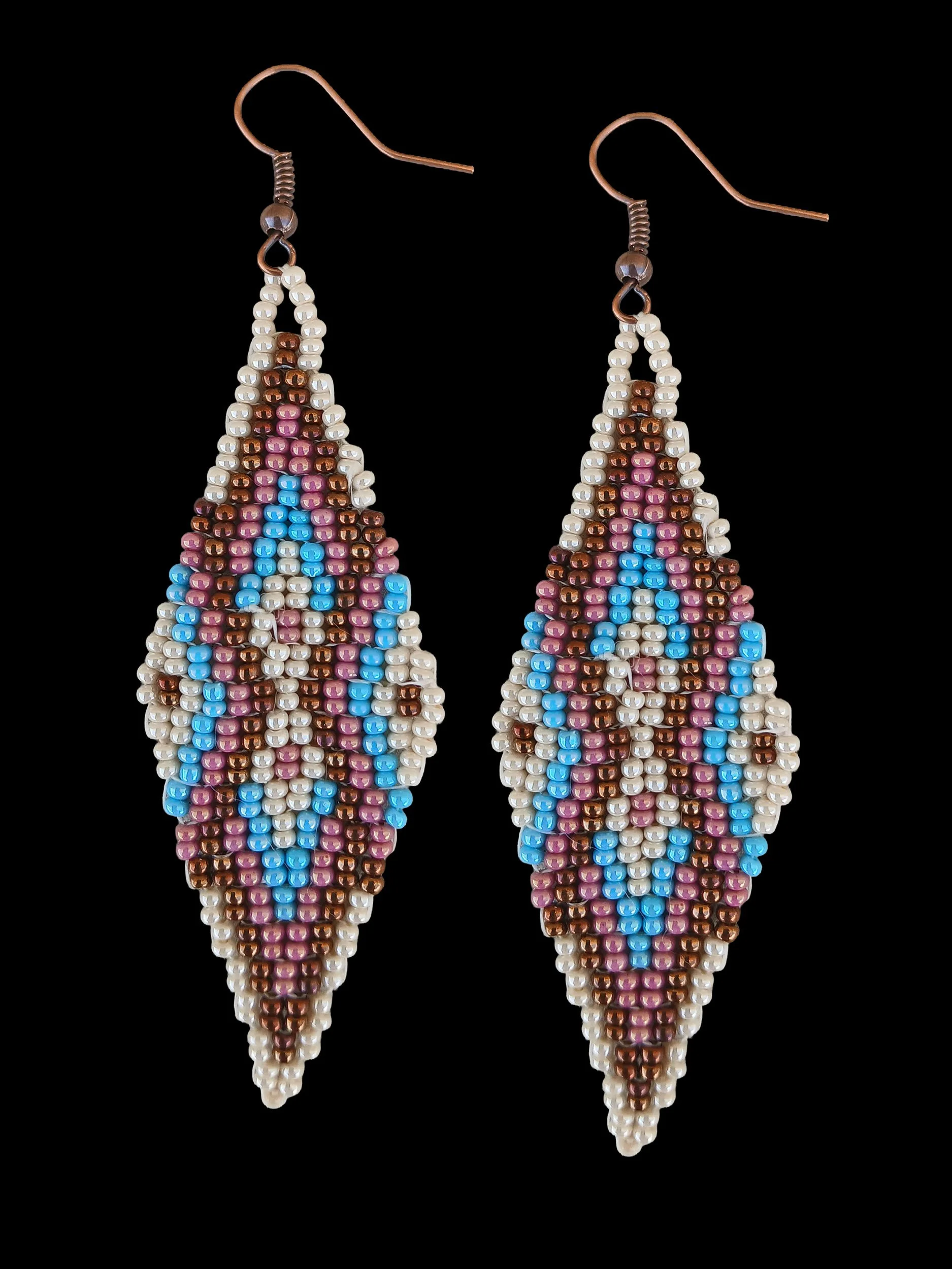 Sedona Sky handmade drop beaded earrings featuring an oblong geometric design handwoven in ivory white, rose luster, sky blue and dark gold.