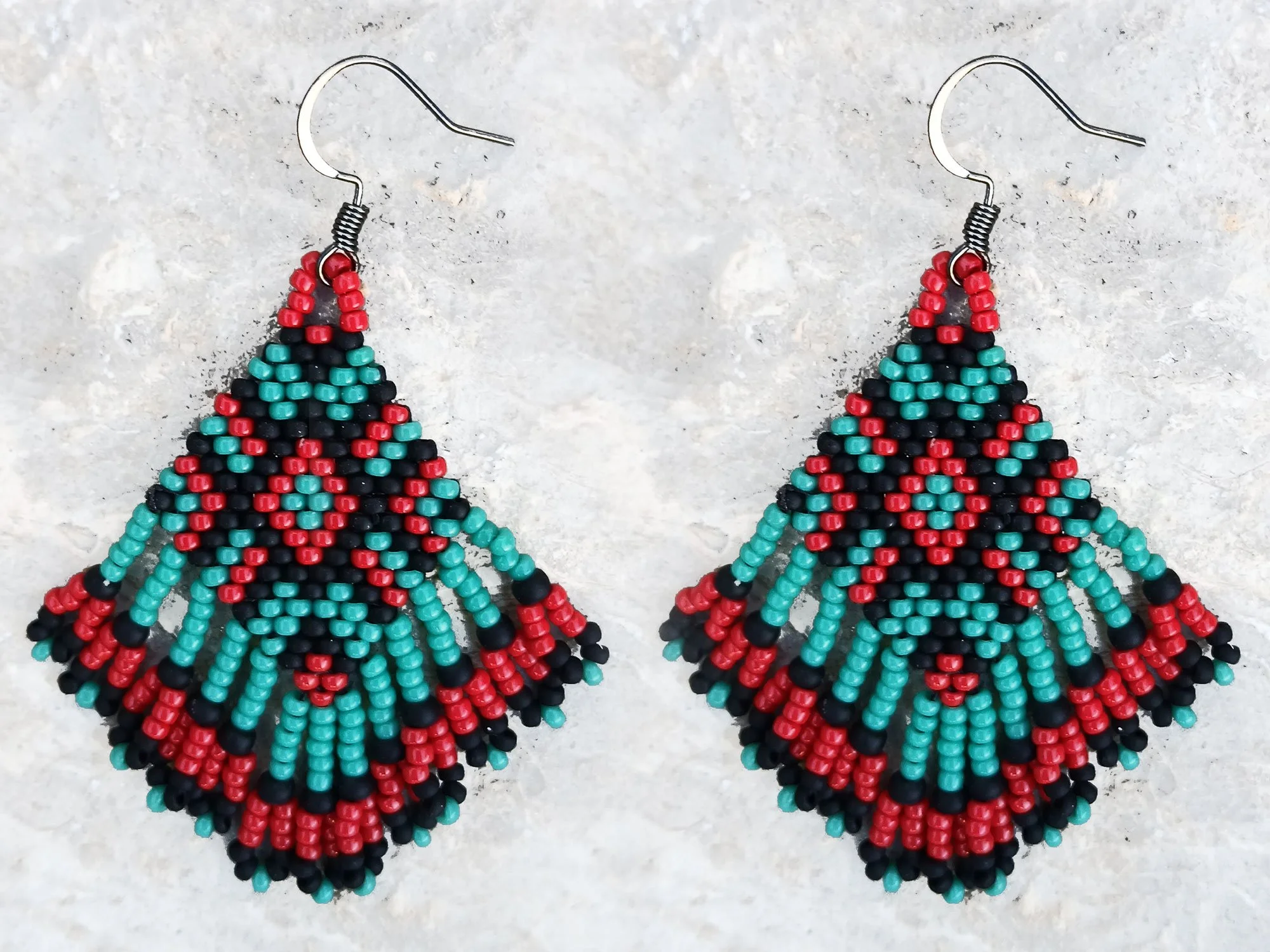 Handmade beaded fringe statement earrings handwoven in red, black, and turquoise with brick stitch in a Western boho style.