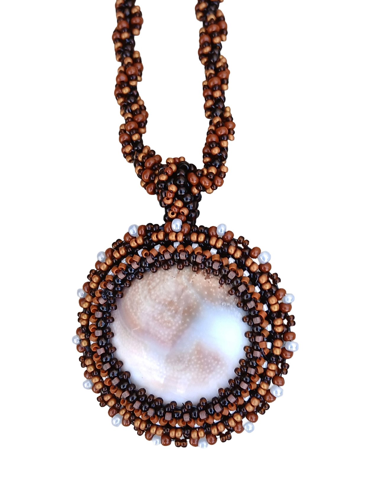 Handmade nature-inspired beaded necklace featuring a beaded bezel on natural spiral Shiva snail shell pendant handwoven in brown and white seed beads.