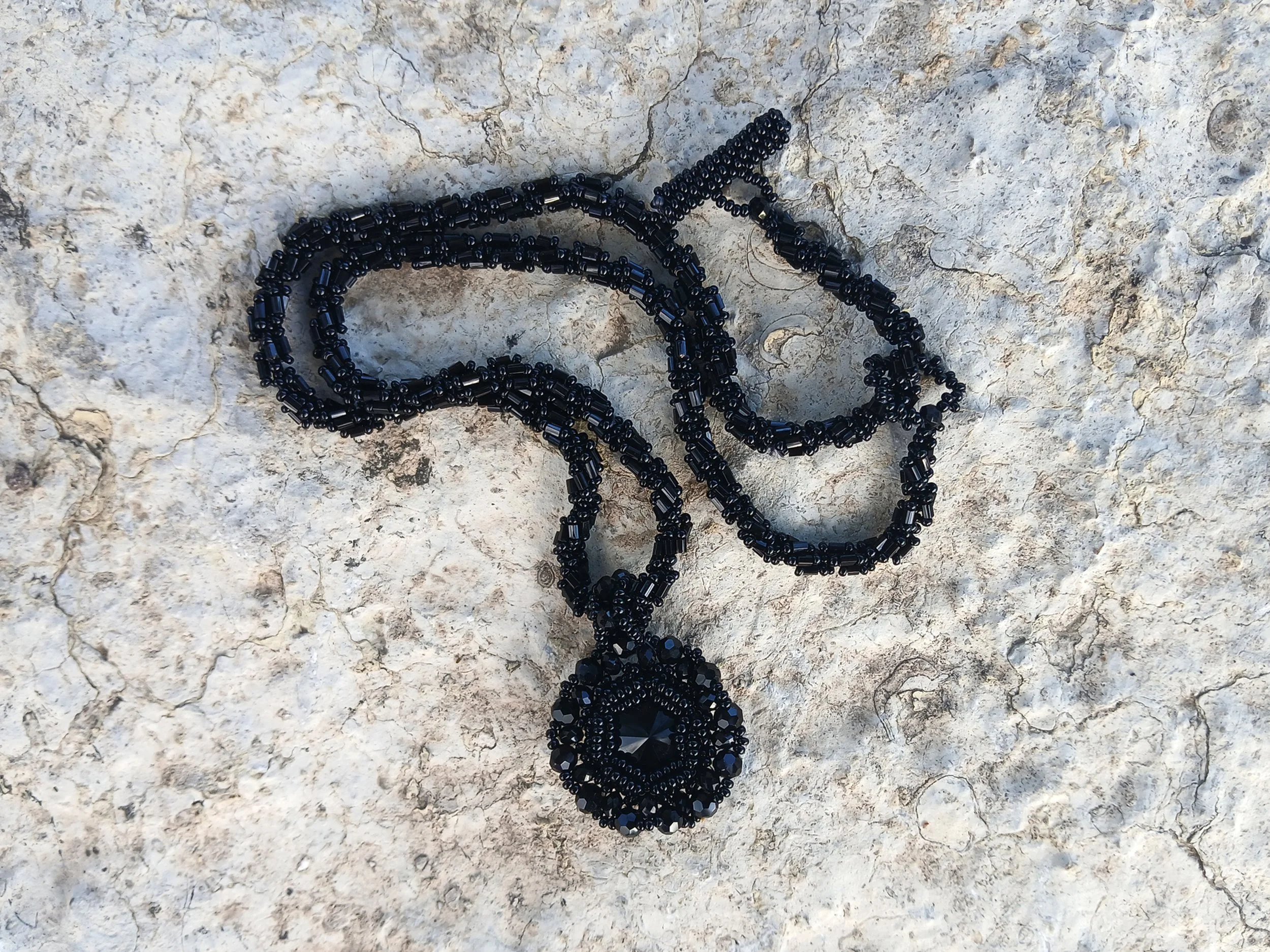 Handmade vintage style necklace with a faceted black Rivoli crystal cabochon and detailed hex bugle and small seed beads