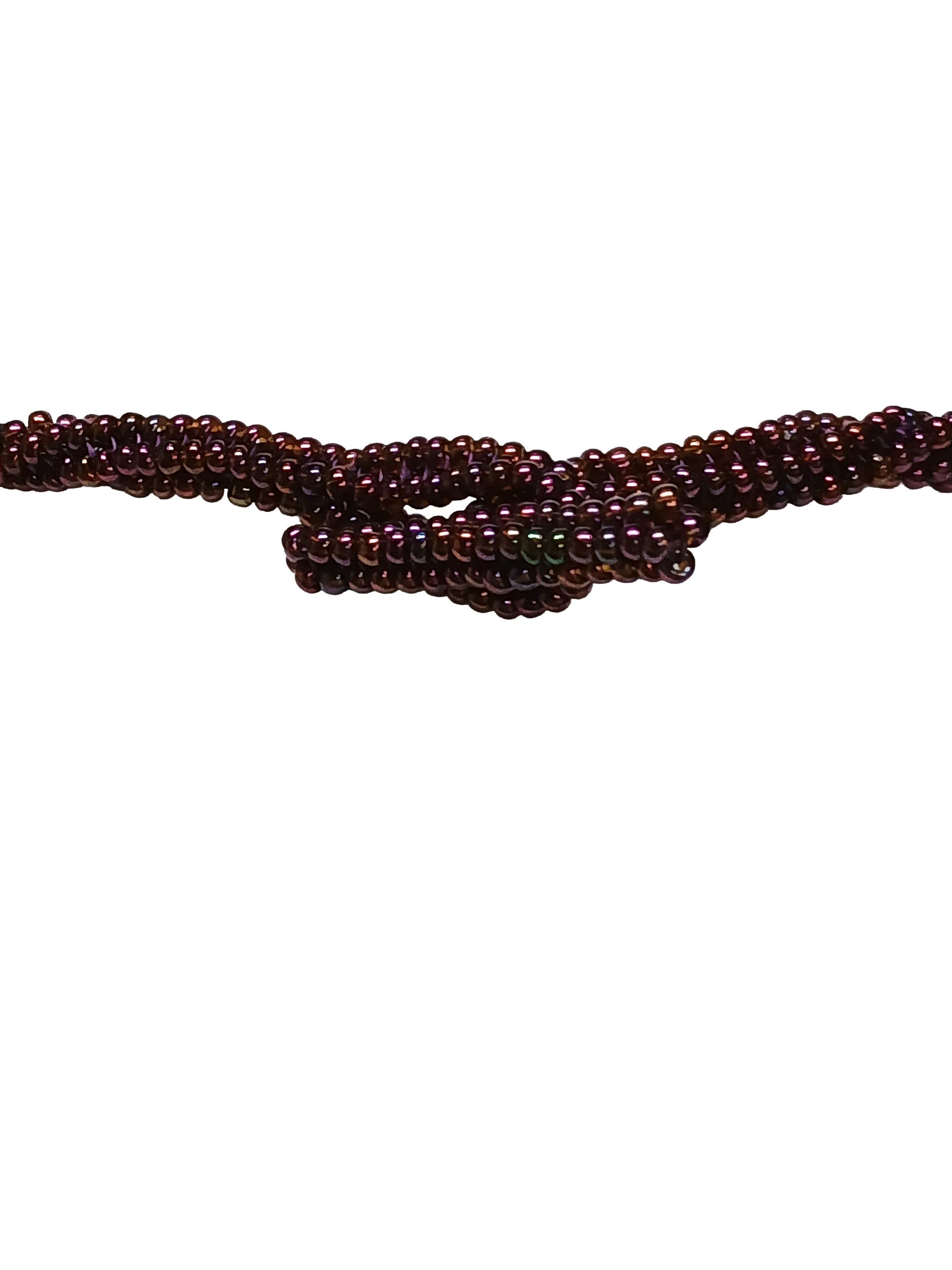 Handmade non-metal beaded rope necklace with open round pendant handwoven in metallic iris rose and gold accents and toggle clasp.