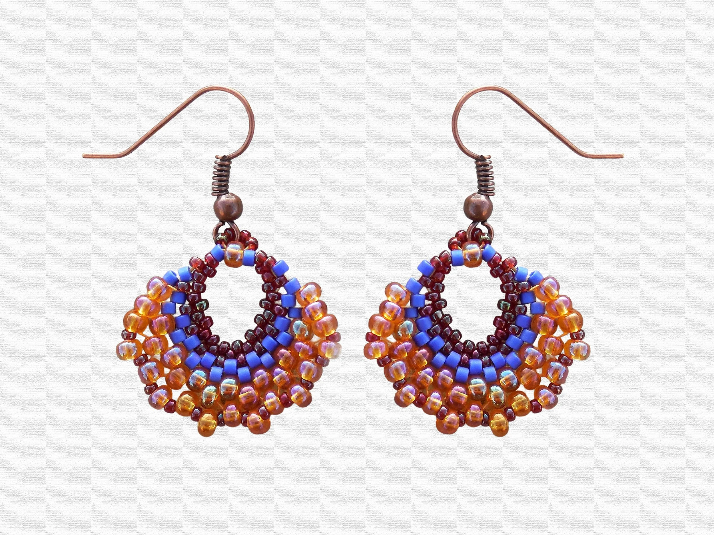 Handmade oval lightweight peyote stitch dangle earrings featuring a seed bead pattern in Blue Red and Orange