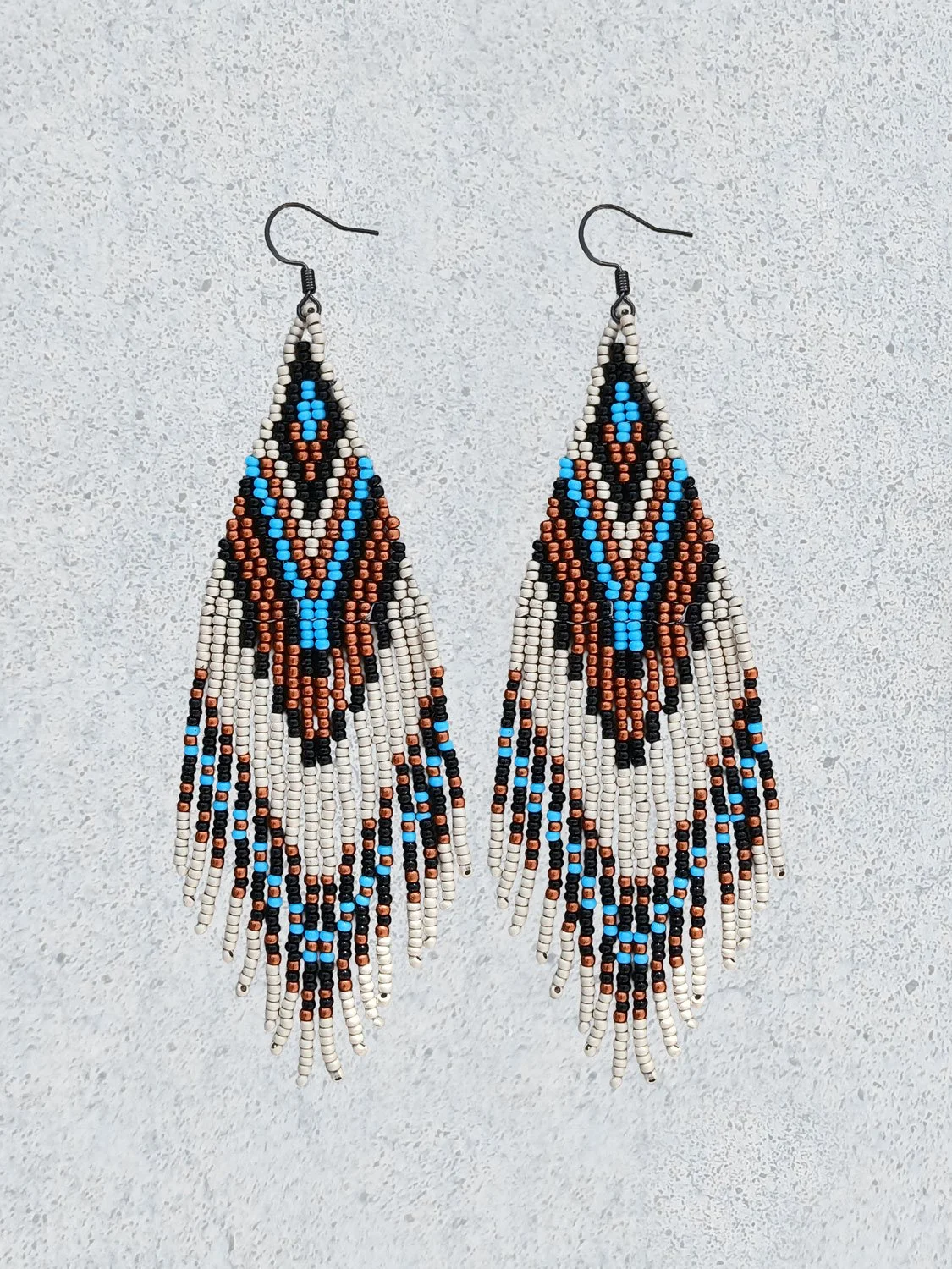 Handmade 5” beaded fringe earrings handwoven in chevron brick stitch with earthy sky blue, matte silver, black, and copper.