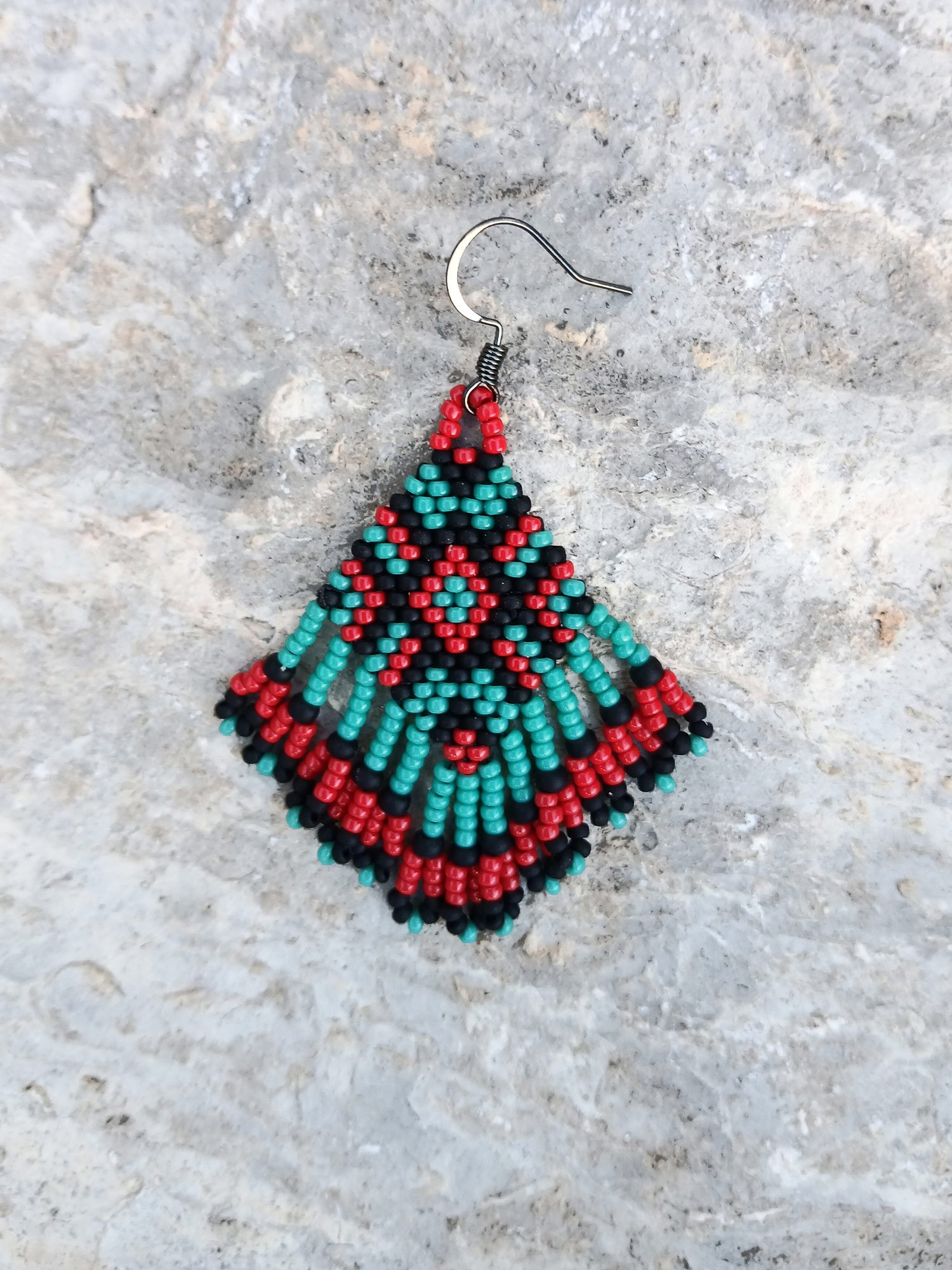 Handmade beaded fringe statement earrings handwoven in red, black, and turquoise with brick stitch in a Western boho style.