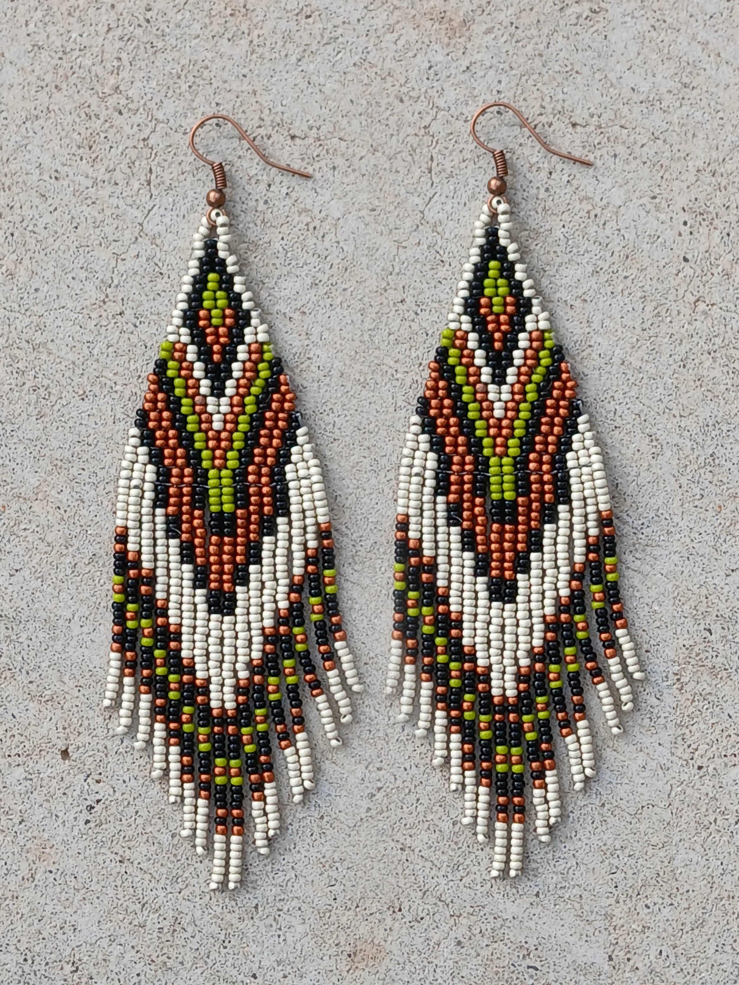 Handmade 5” beaded fringe earrings handwoven in chevron brick stitch with earthy green, matte silver, black, and copper.
