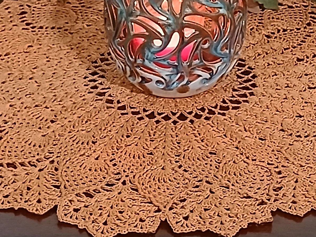 Exquisite and highly detailed 17-inch round crochet lace doily handwoven in a warm topaz color with a dimensional pineapple pattern