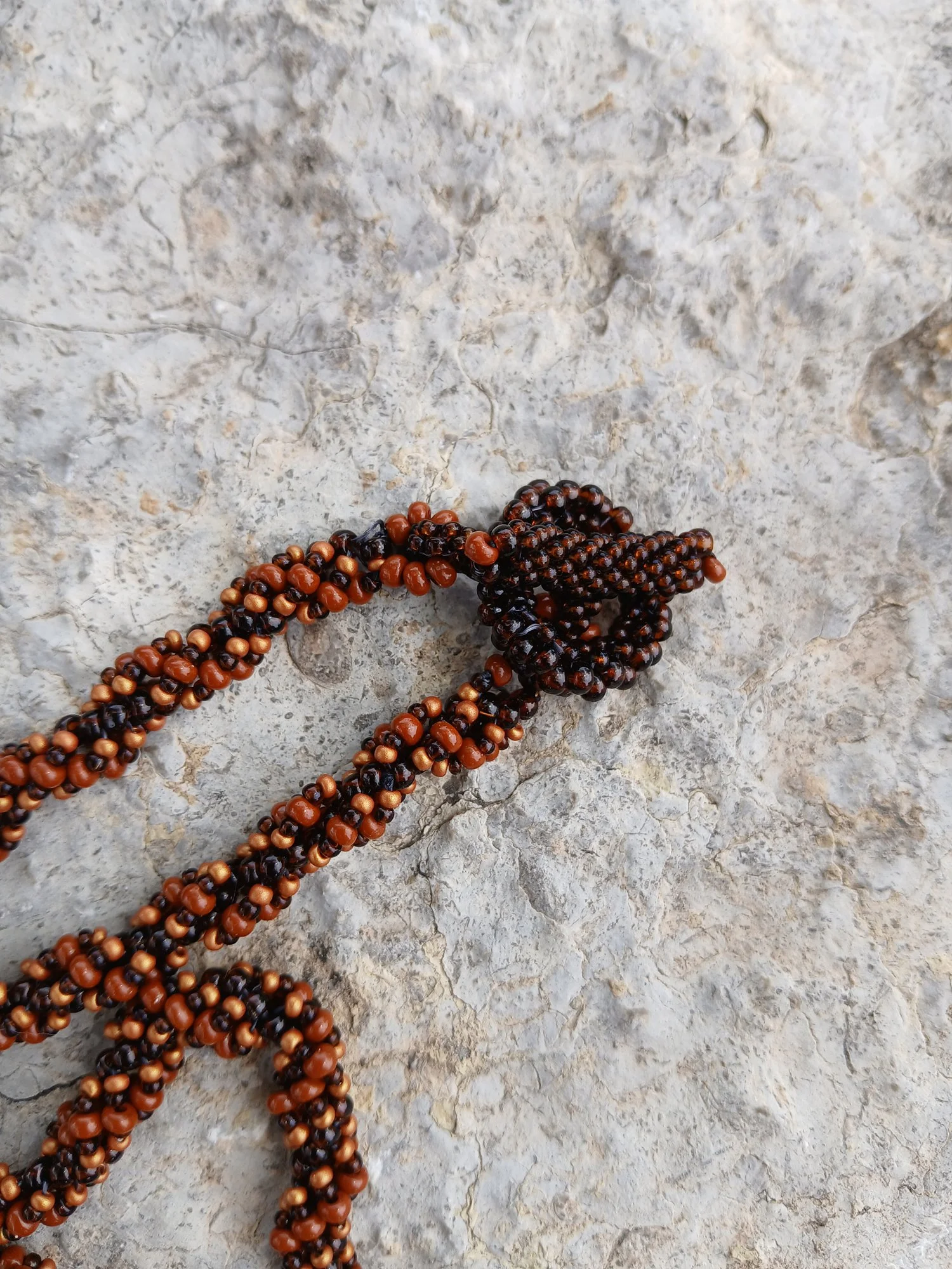 Handmade Boho-style necklace with a natural spiral Shiva eye shell pendant on a seed bead chain