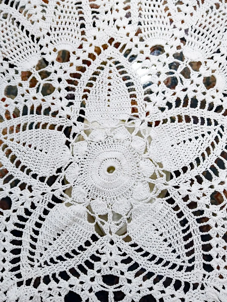 Handmade extra-large 22-inch round white crochet lace doily featuring an intricate pointed pineapple design