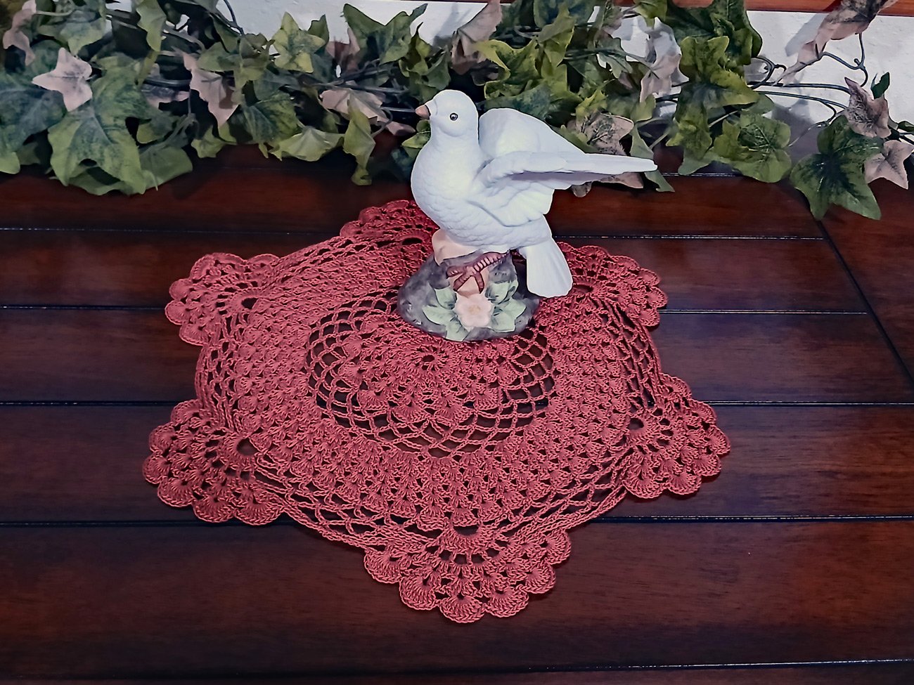 Handmade 13-inch round crochet lace doily in a rich rust orange color featuring intricate scalloped edges and pointed details