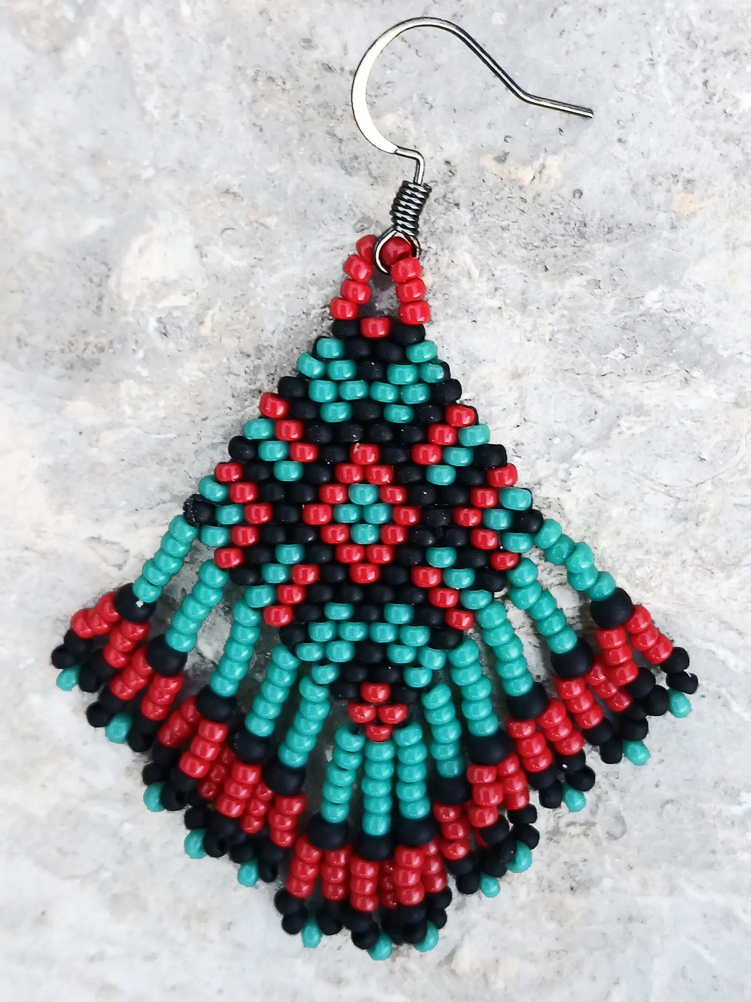 Handmade beaded fringe statement earrings handwoven in red, black, and turquoise with brick stitch in a Western boho style.